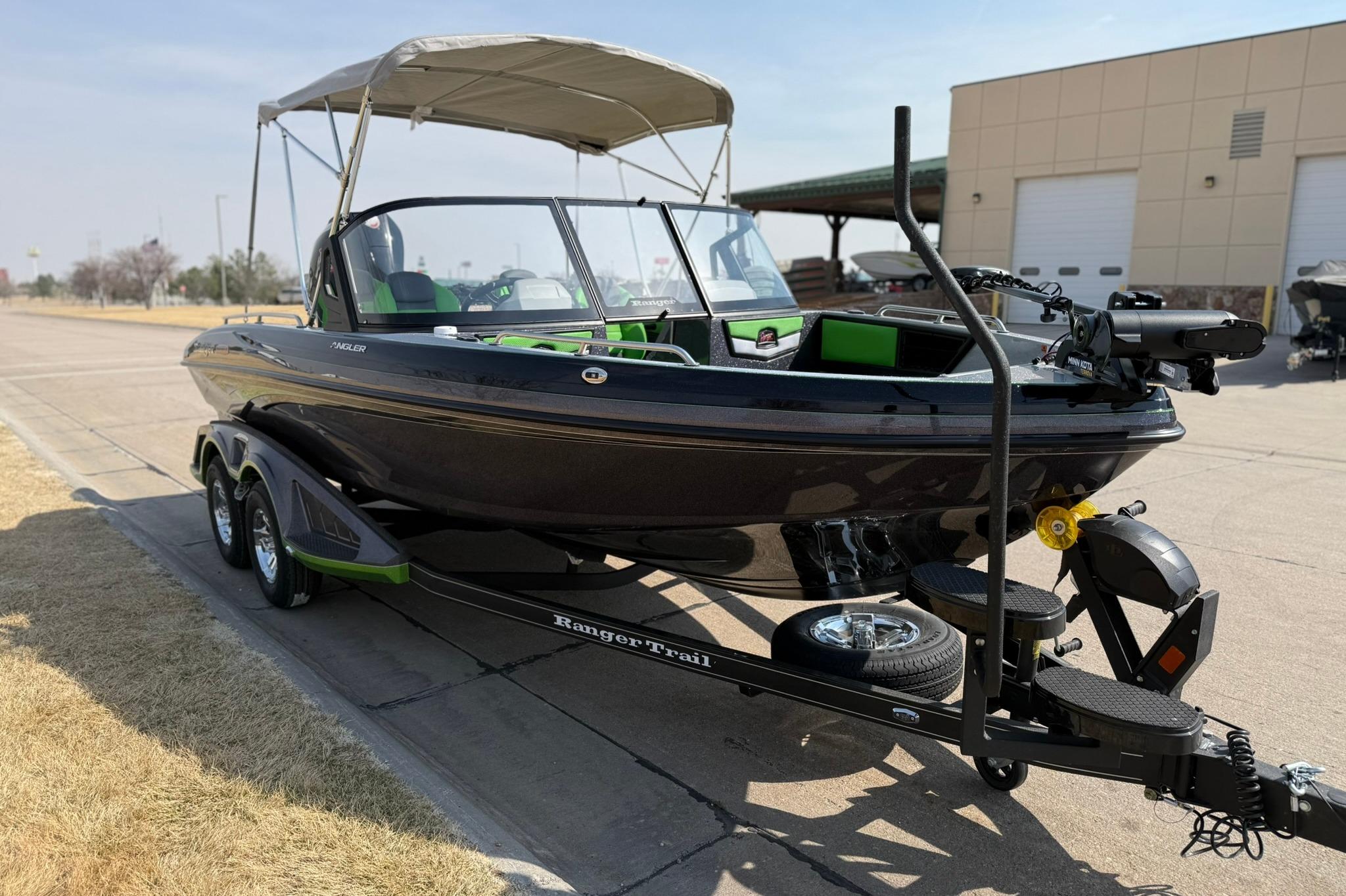 2026 Ranger 1880MS boat on trailer, parked outdoors, featuring sleek design and canopy.