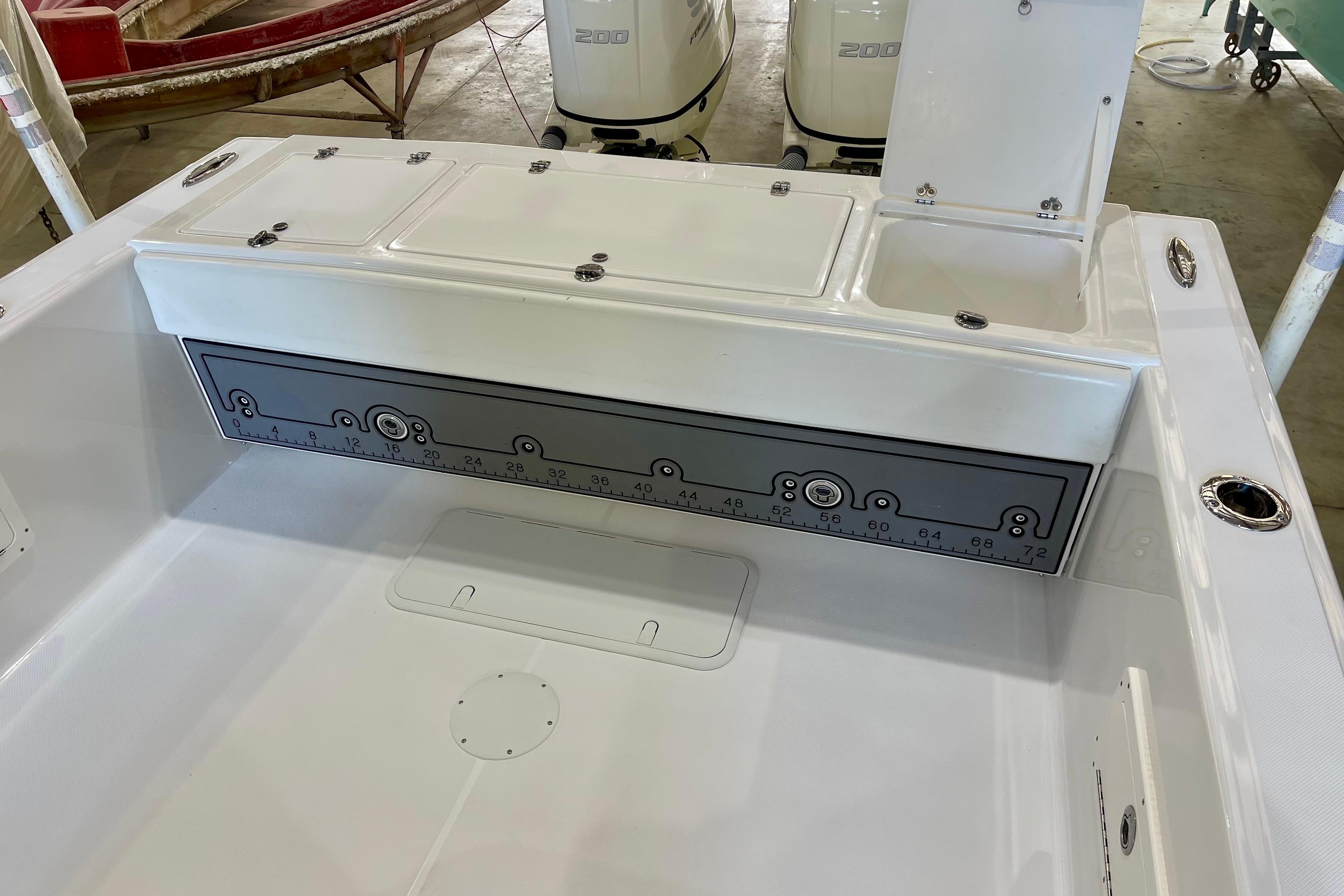2025 Ocean Master 296 Center Console boat interior with storage compartments and measurement panel.