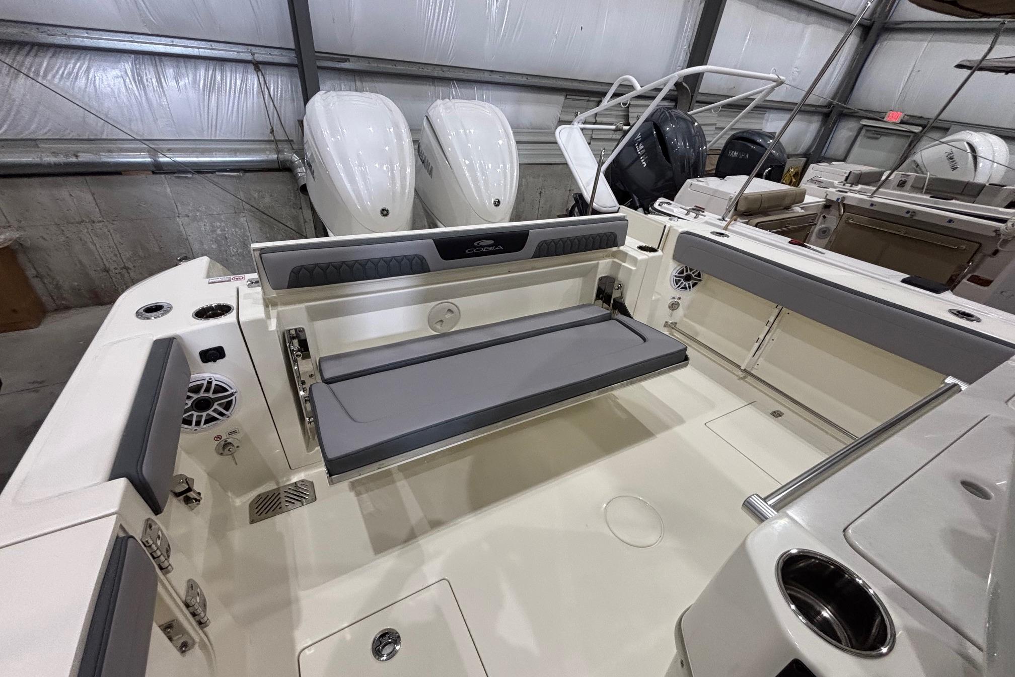 2026 Cobia 285 Open Center Console boat interior with seating and dual engines.