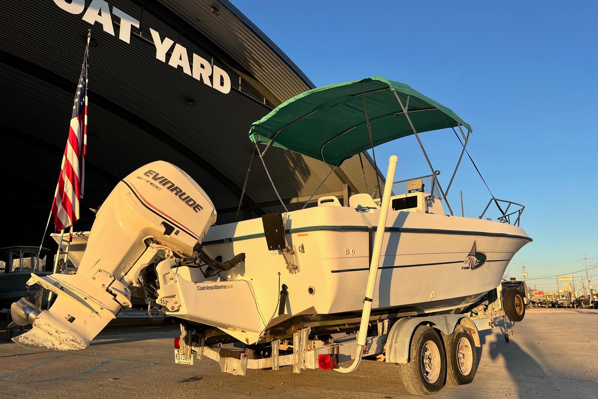 1998 Sunbird 230 CC boat with Evinrude engine on trailer at boat yard.