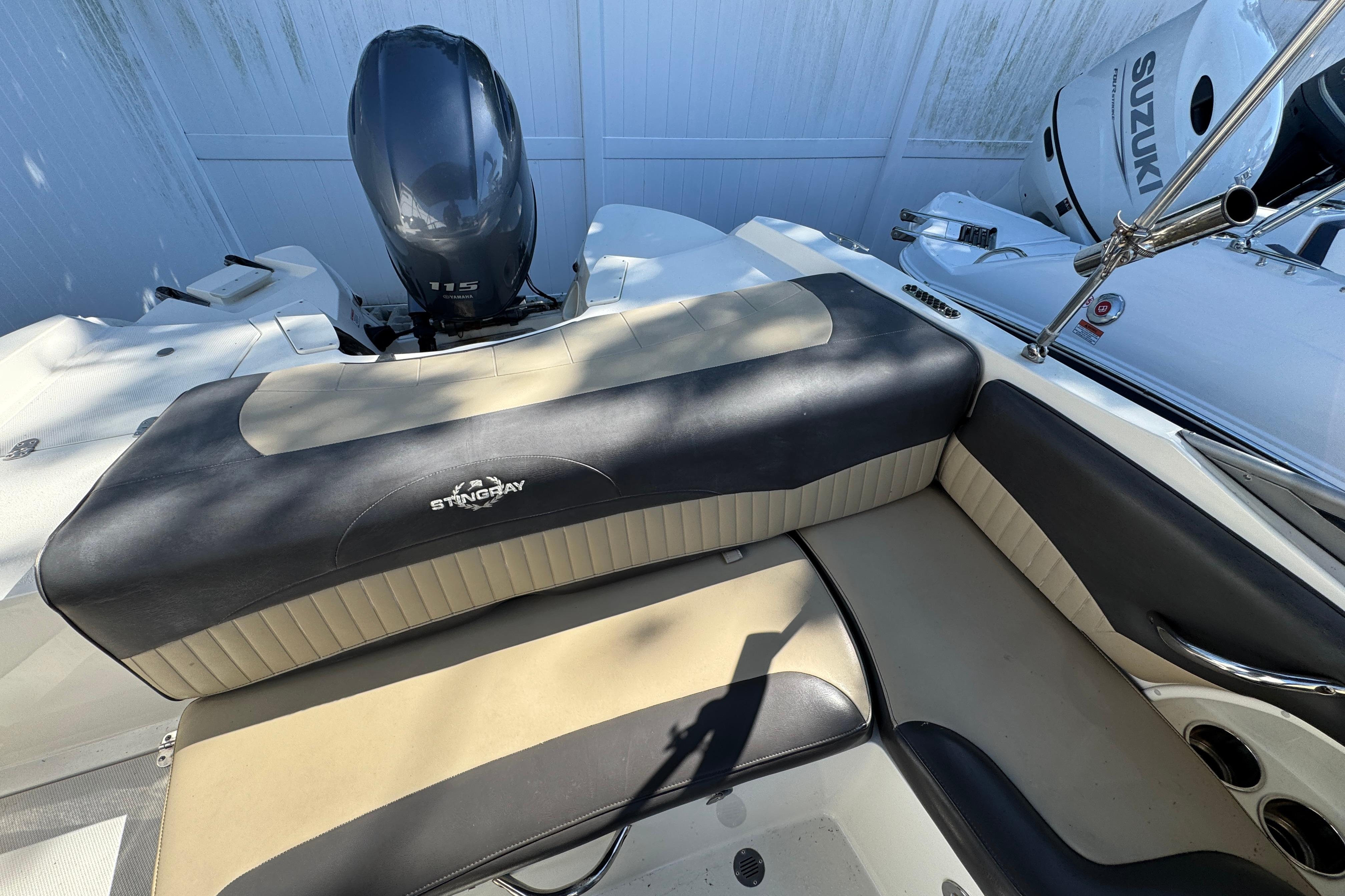 2018 Stingray 204 LR boat interior with seating and outboard motor.