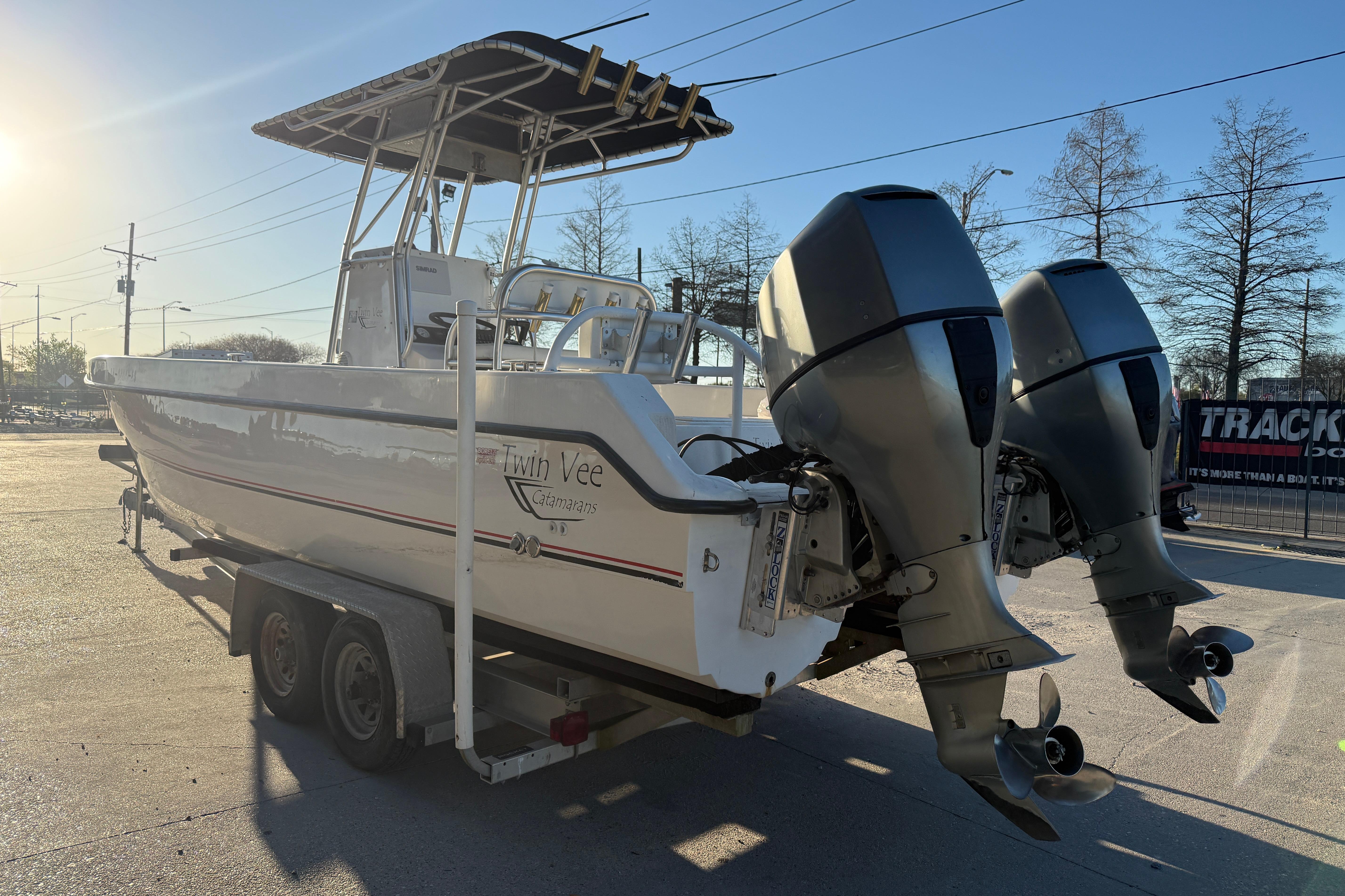 2007 Twin Vee 26 Center Console boat on trailer, dual outboard motors.