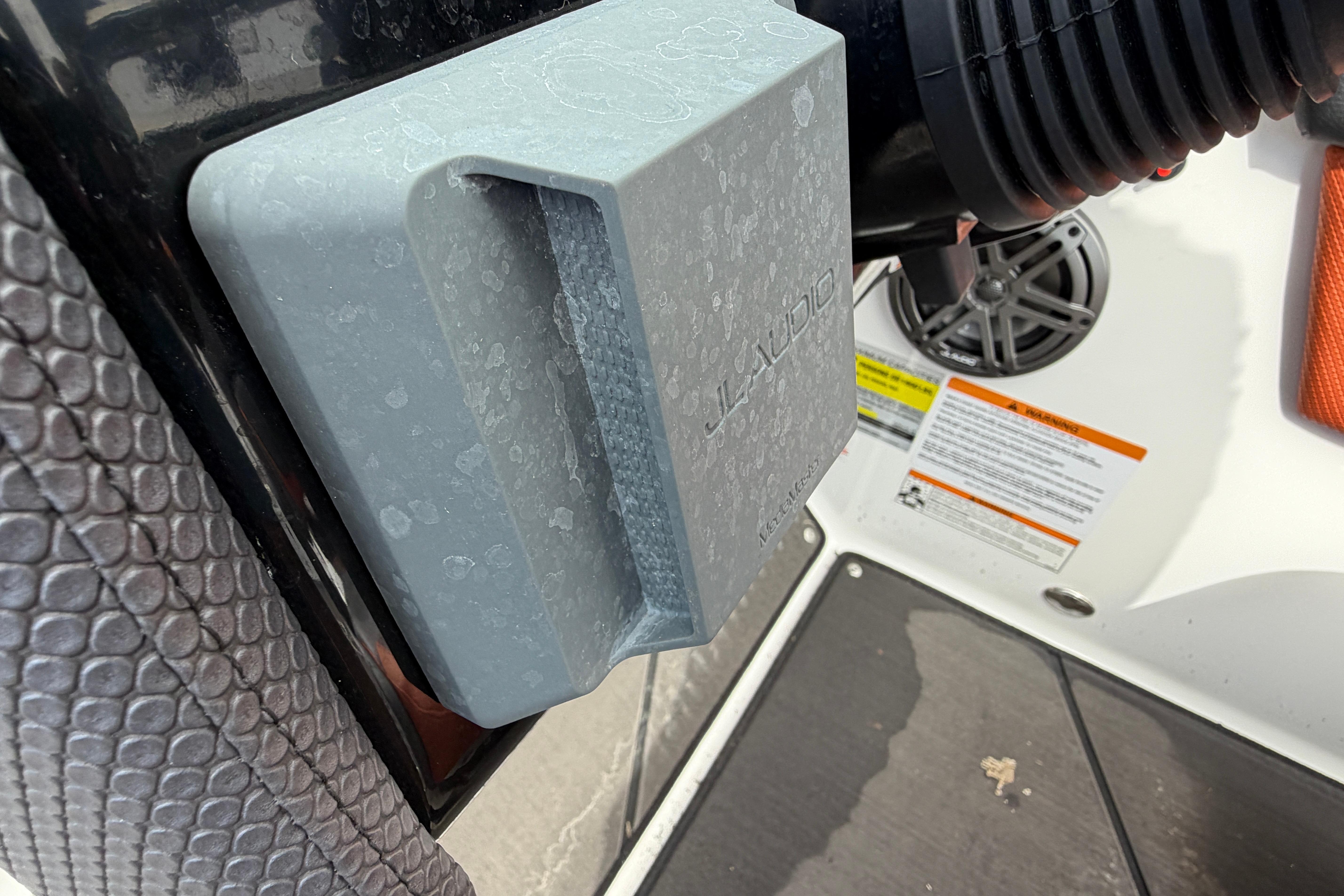 Close-up of a 2026 Scarab 235 LX boat's JL Audio speaker and textured surface.