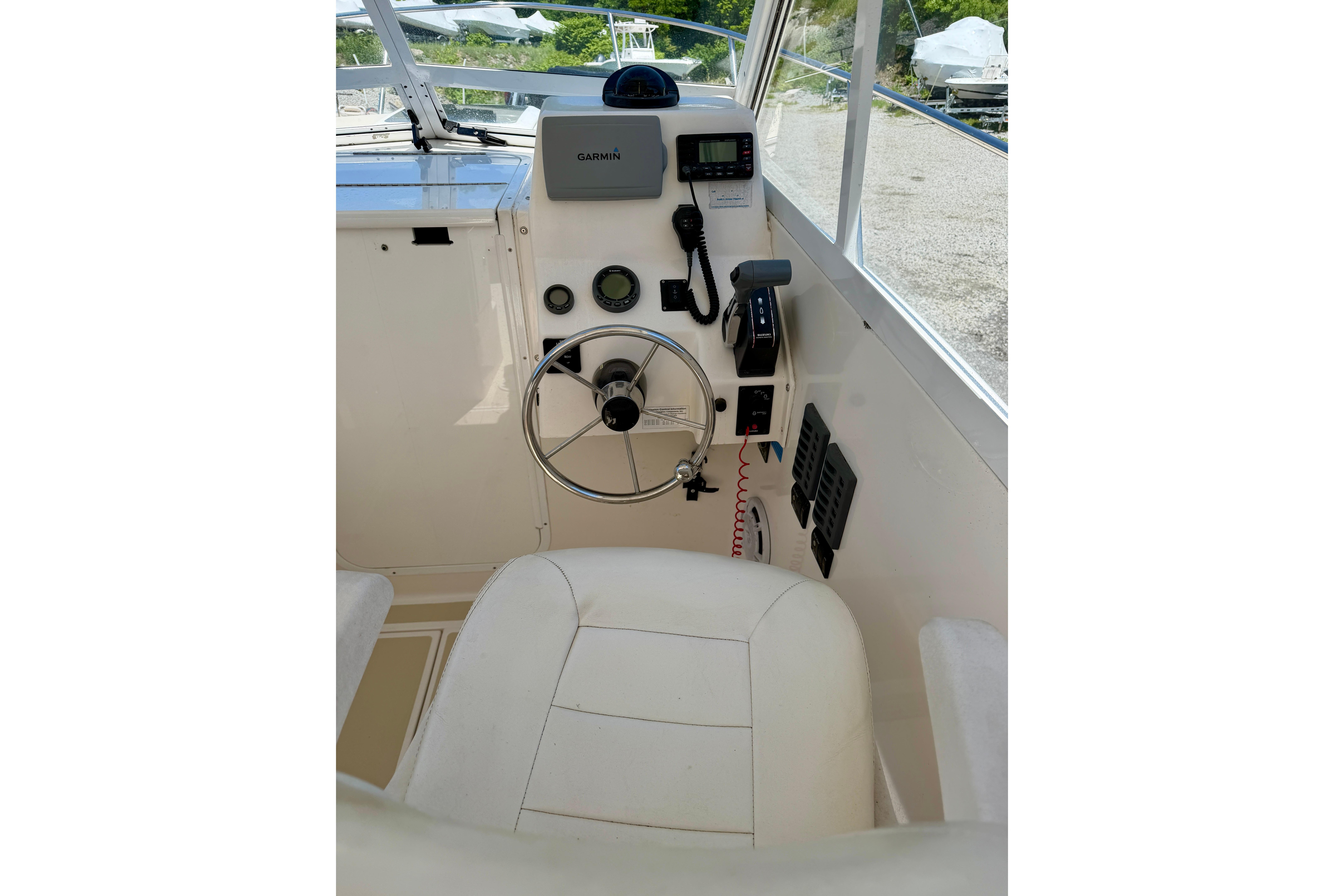 Helm of 2007 NorthCoast 235 HT boat with steering wheel and navigation equipment.