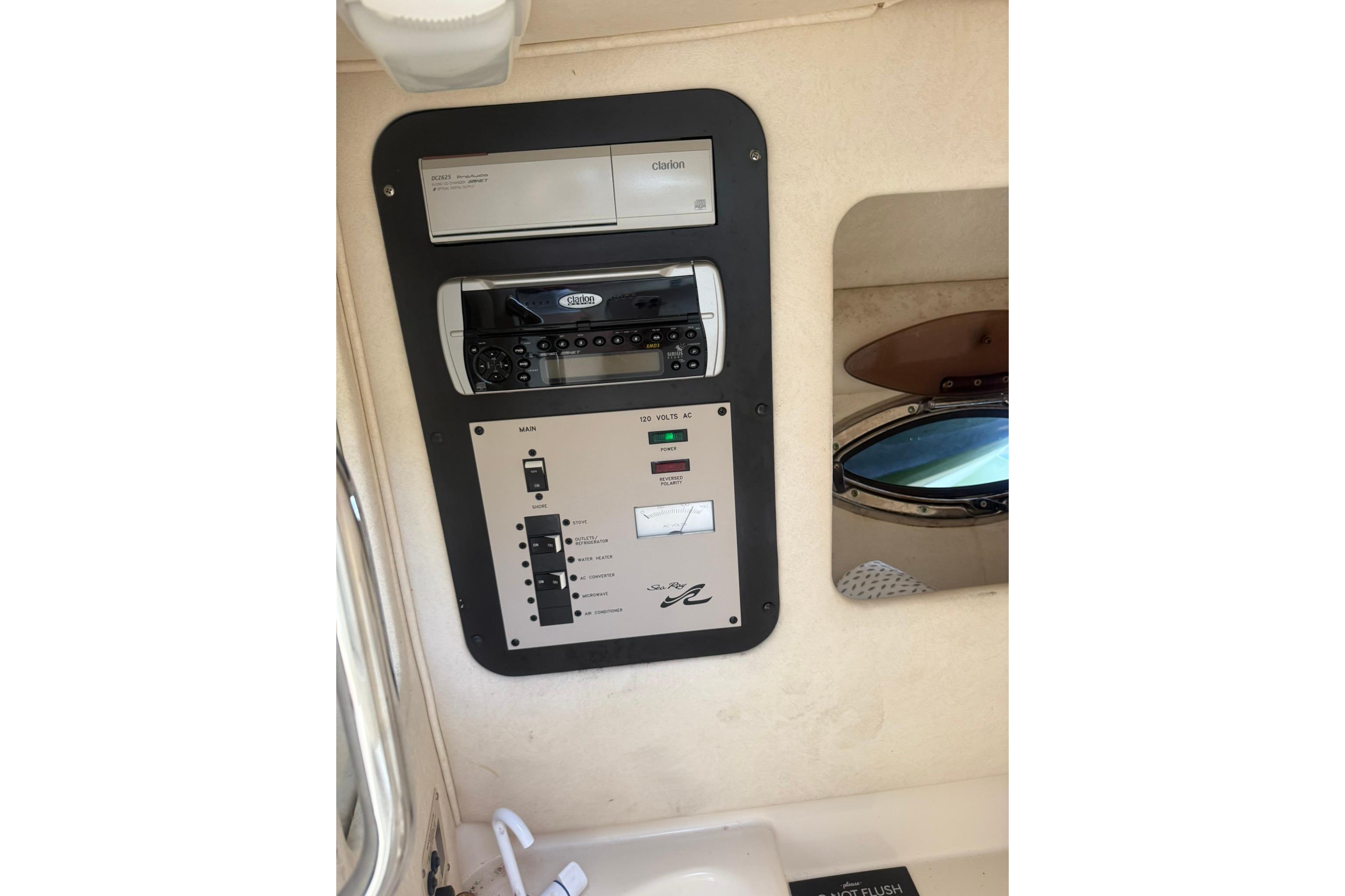 Control panel of a 2005 Sea Ray 290 SLX boat, featuring stereo and electrical switches.