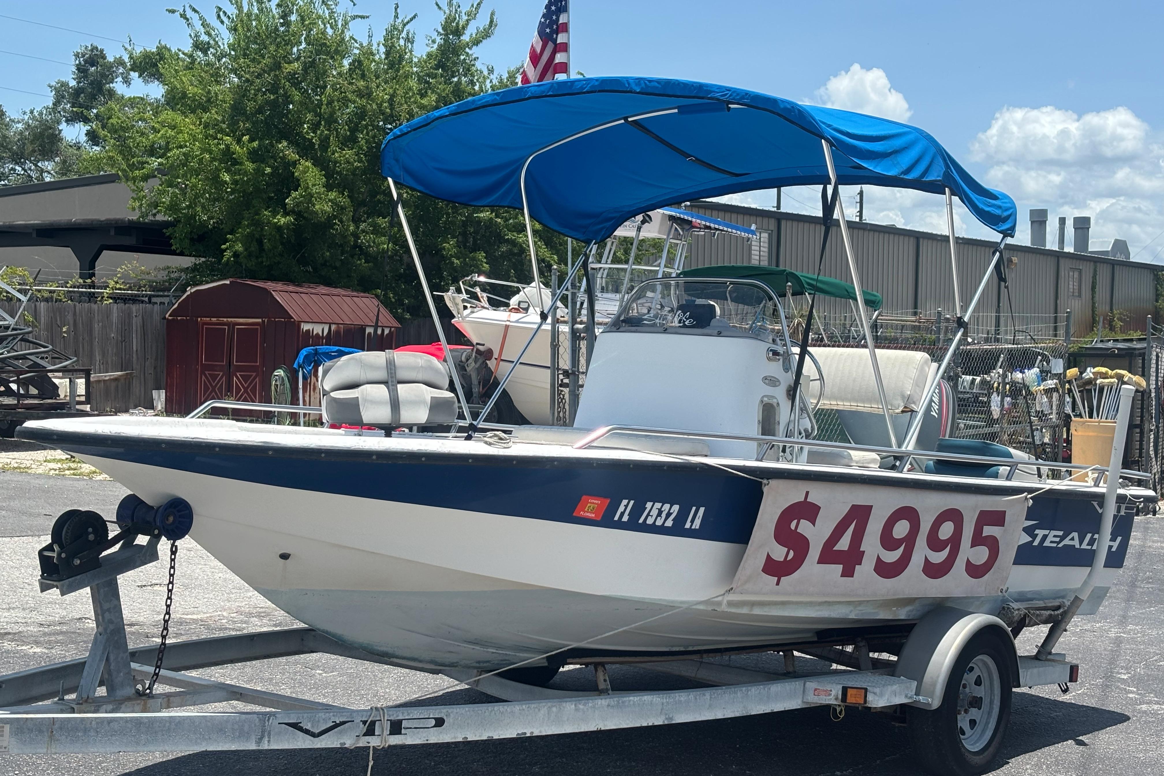 2000 VIP 1880 BAY STEALTH boat with blue canopy, priced at $4995, on trailer.