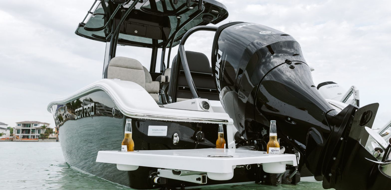 Seapro 245 FLX Sandbar 2024 on water with drinks on platform.