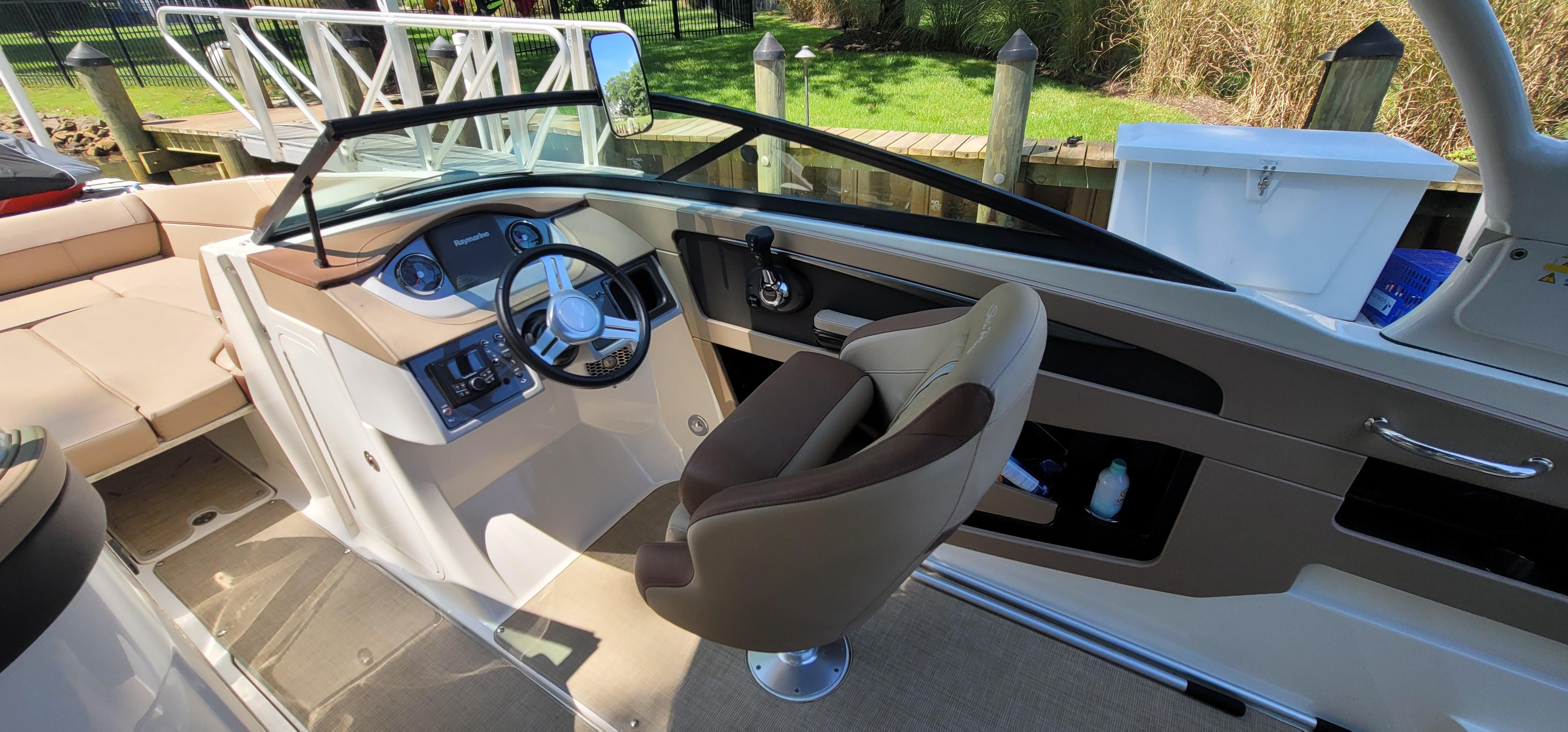 2017 Sea Ray SDX 240 Outboard boat interior with helm and seating area.