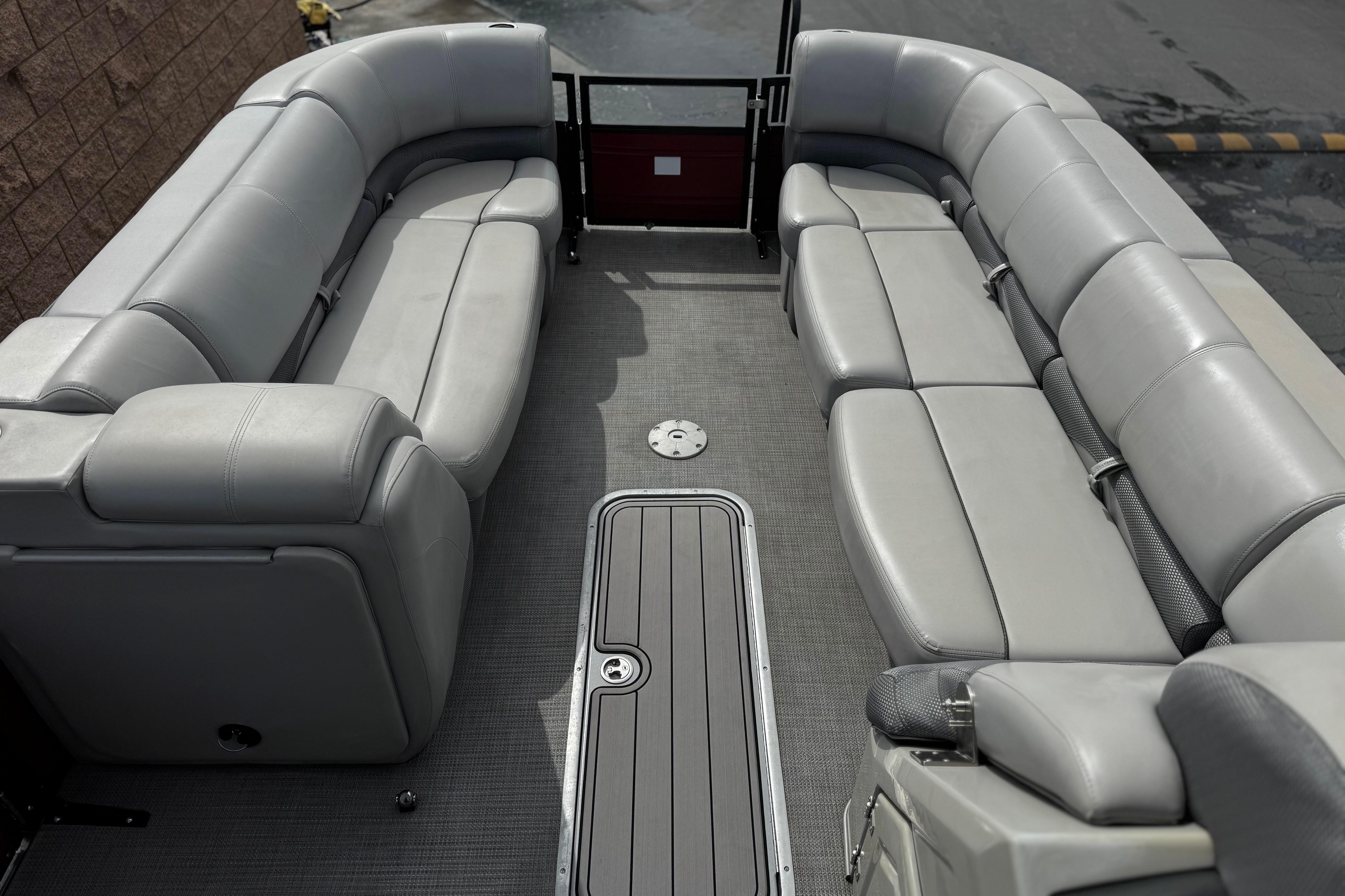 Luxurious interior of 2022 Regency 250 DL3 pontoon boat with plush seating.