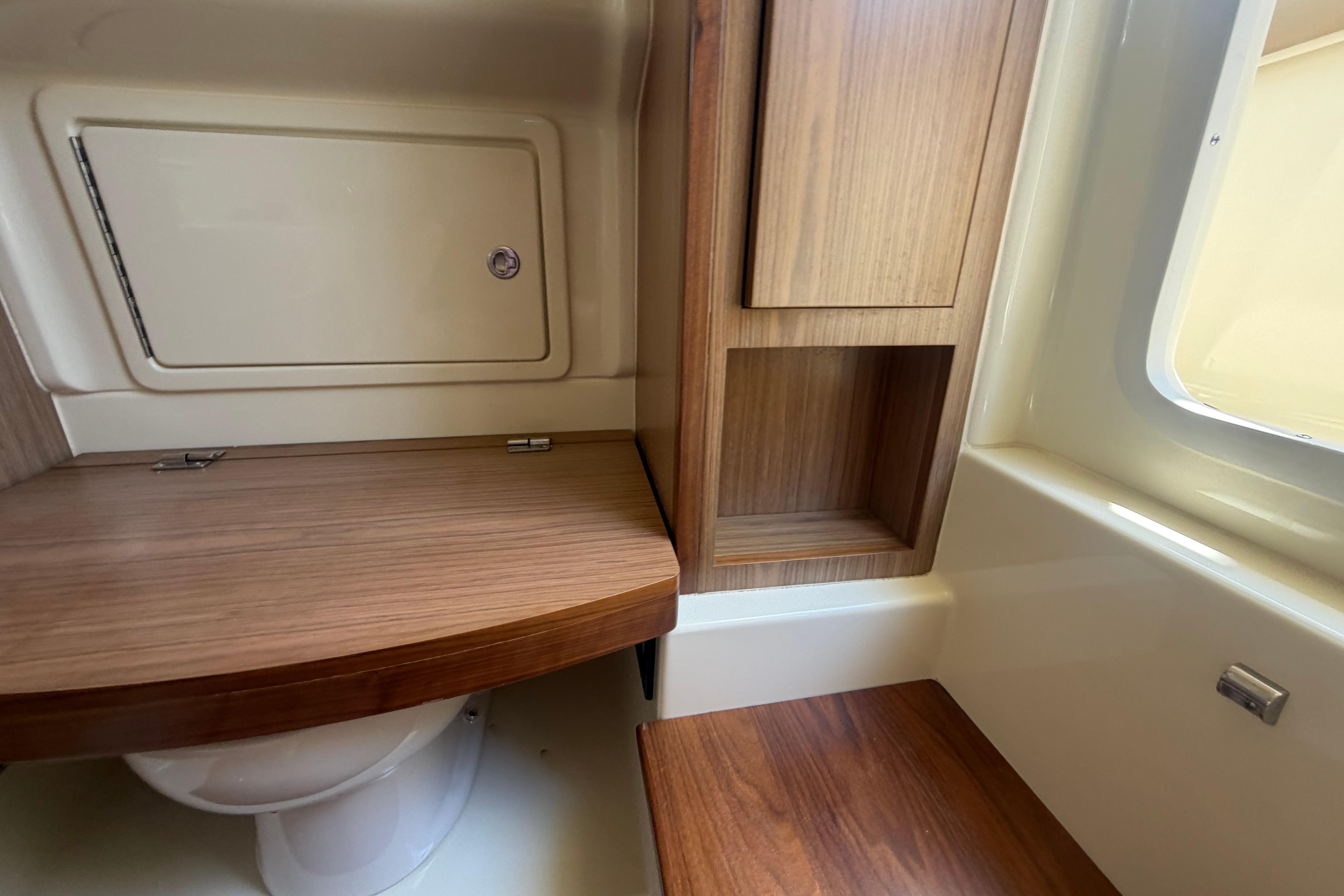 2017 Chris-Craft Catalina 34 interior bathroom with wooden cabinetry and compact design.
