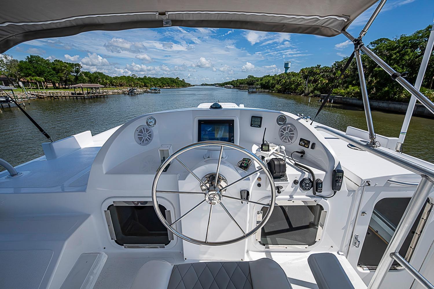 Cockpit view of 2003 Magna Marine Nova Scotia 47 yacht on a scenic river.