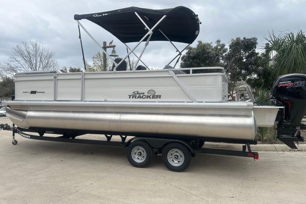 2026 Sun Tracker Party Barge 22 RF DLX pontoon boat with canopy and trailer.