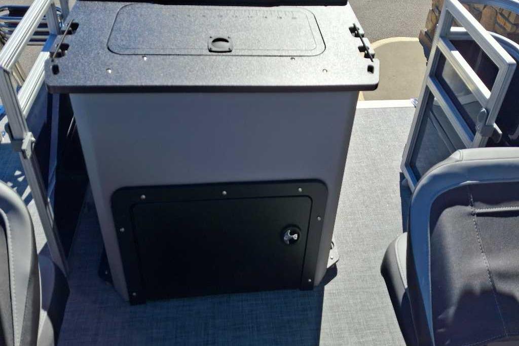 2026 Sun Tracker SportFish 20 DLX boat interior with storage compartment and seating.