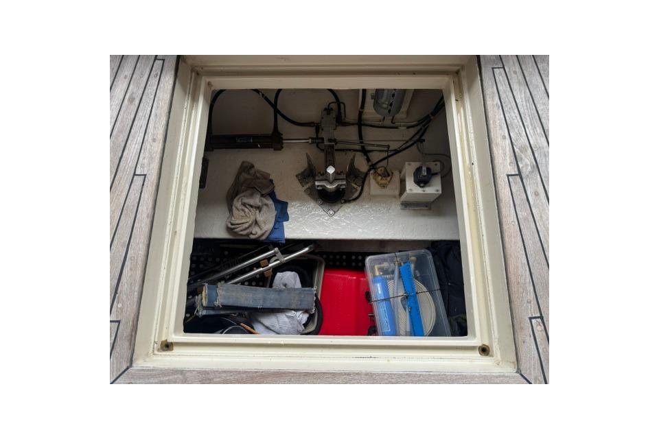 Storage compartment of a 1986 Kadey-Krogen 42 boat, containing tools and equipment.