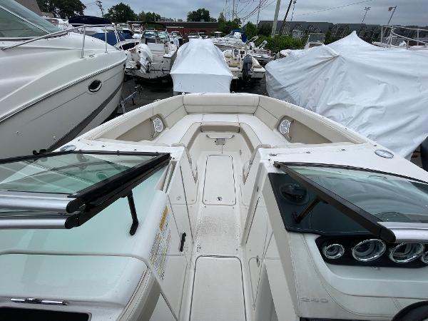 2013 Sea Ray 240 Sundeck boat interior with open bow seating, docked among other boats.