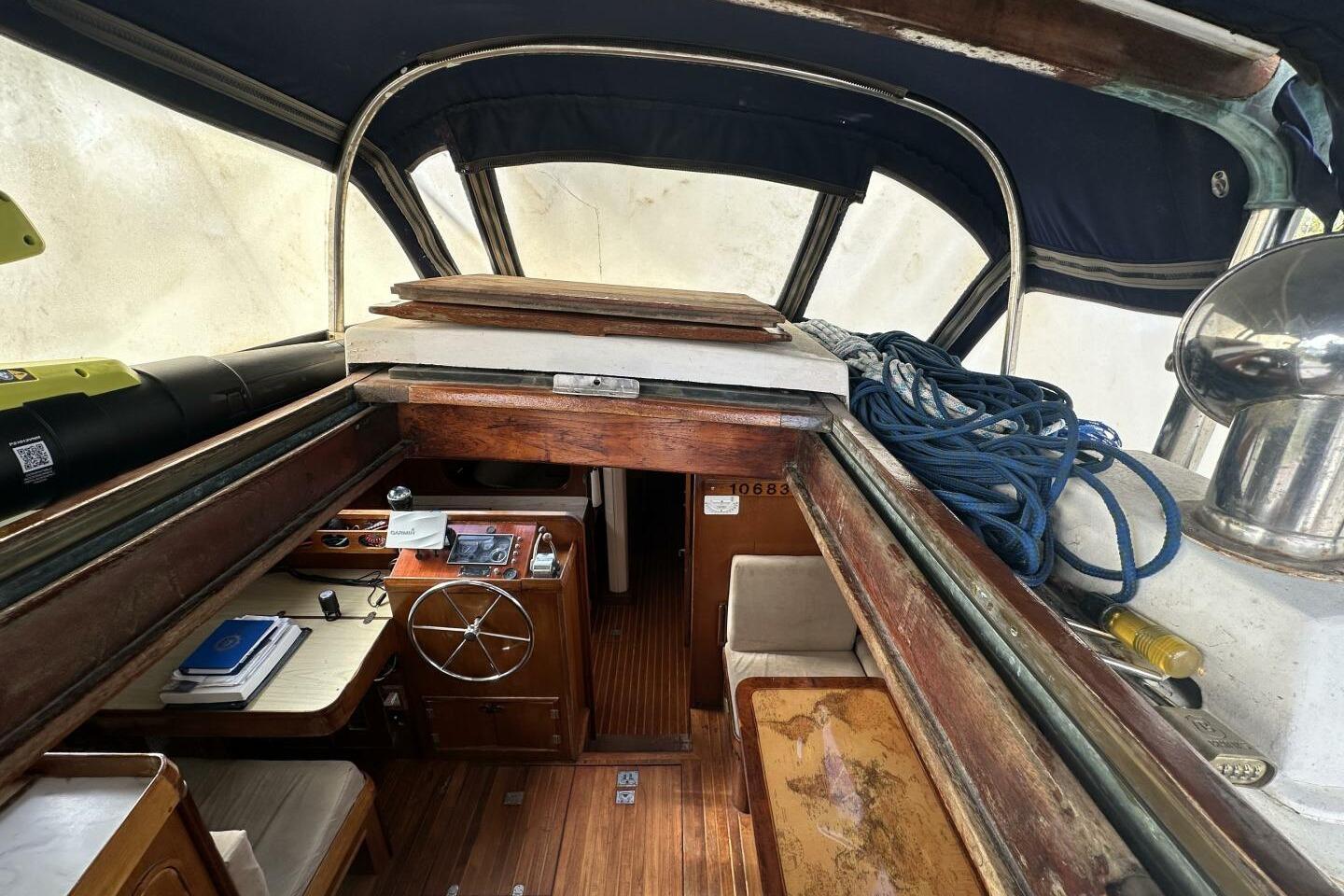 Interior of a 1986 Pan-Oceanic 46 sailboat with wooden finishes and nautical equipment.