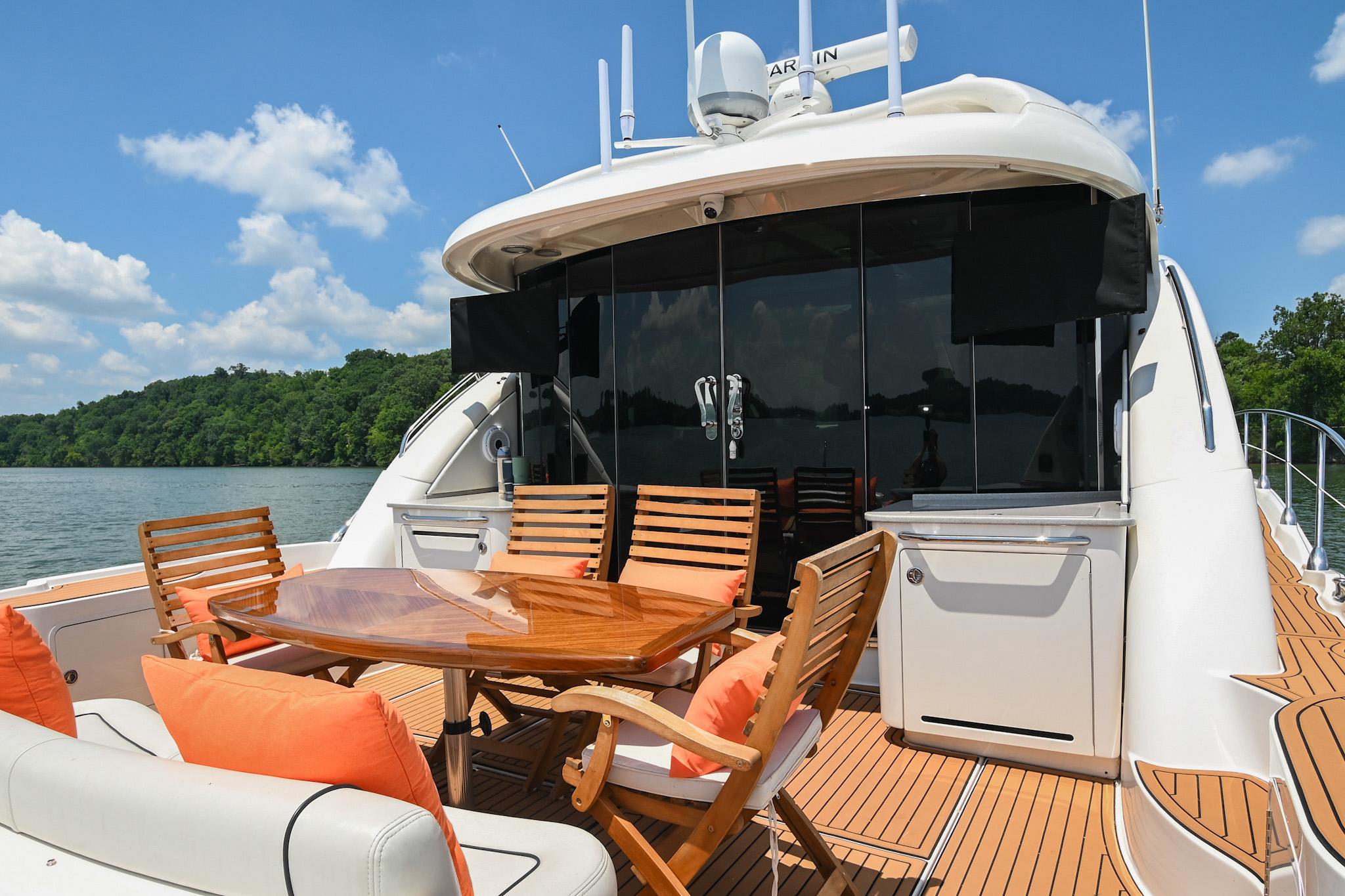 Luxurious 2007 Sea Ray 60 Sundancer yacht with elegant outdoor seating and scenic water view.