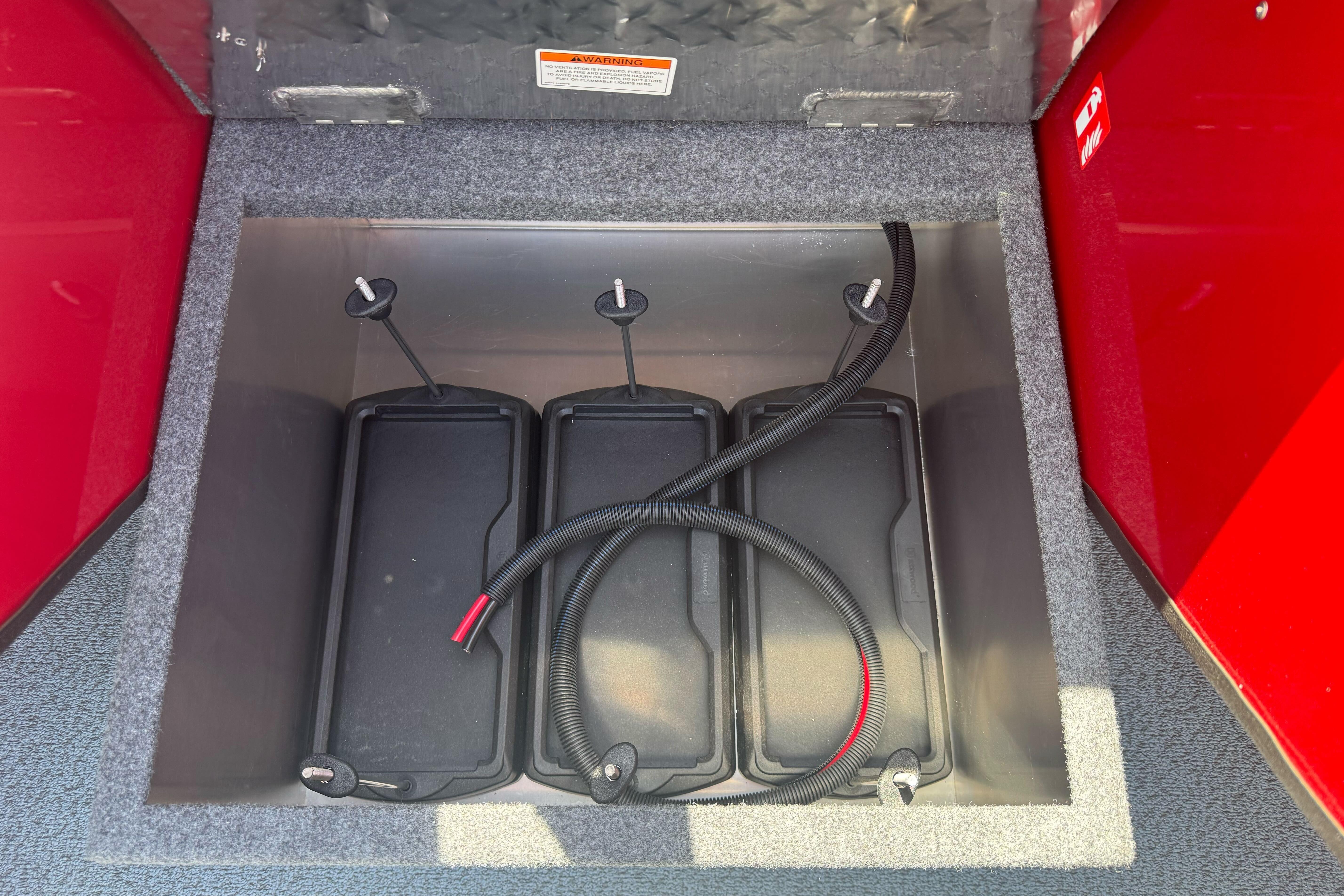 Battery compartment of 2026 Lund 210 Heavy Gauge boat with three batteries.