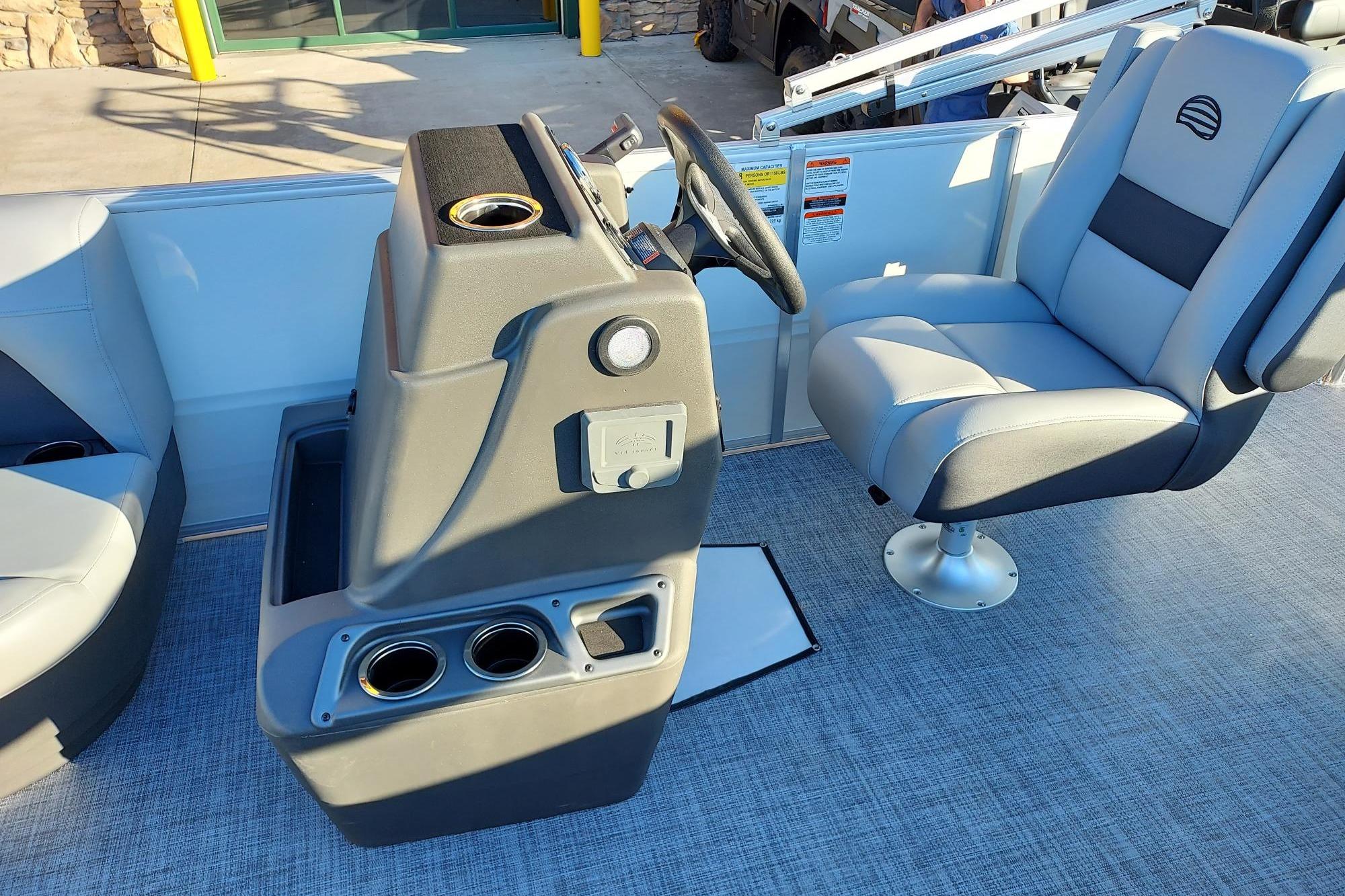 2026 Sun Tracker Party Barge 16 DLX interior with helm and seating area.