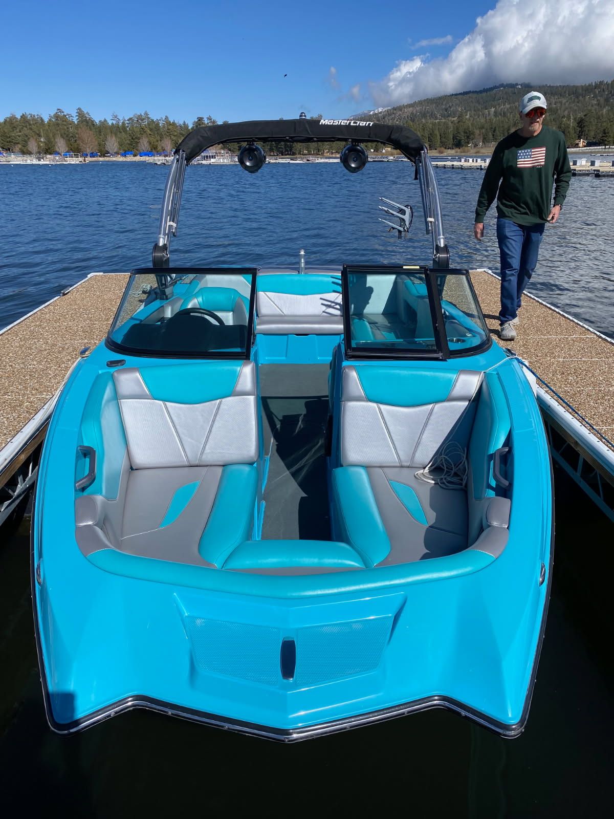2021 MasterCraft NXT22 boat at dock with blue interior.