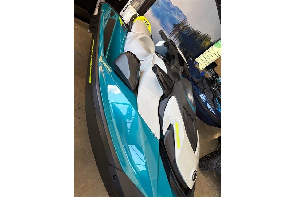 2025 Sea-Doo GTI SE 130 jet ski in showroom, featuring sleek design and vibrant colors.