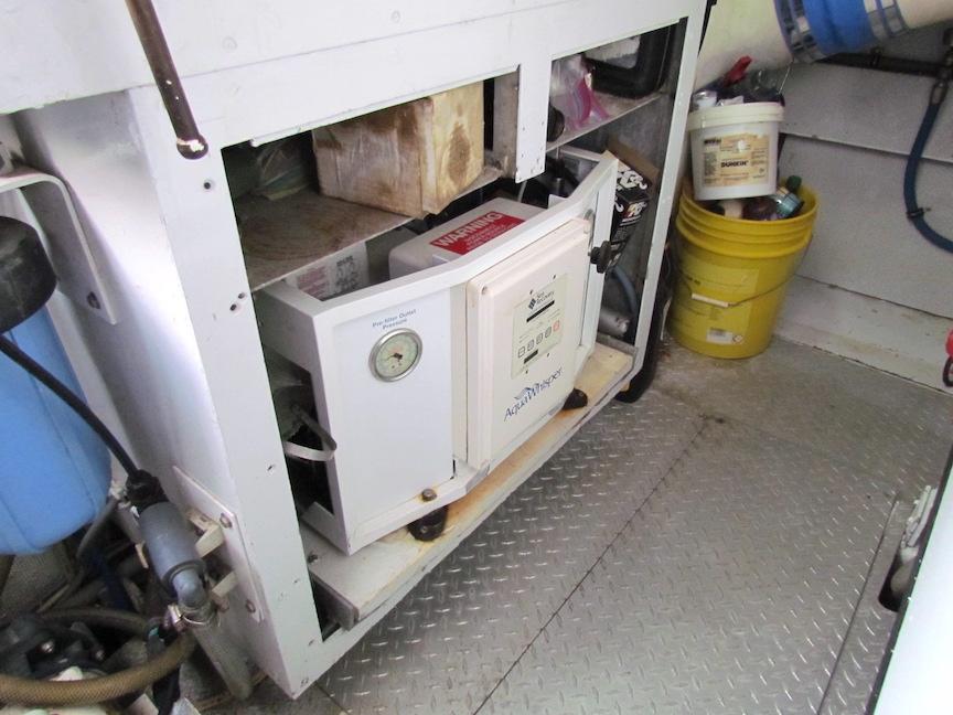 Engine room of 1972 Hargrave 67 Motor Yacht with equipment and storage.