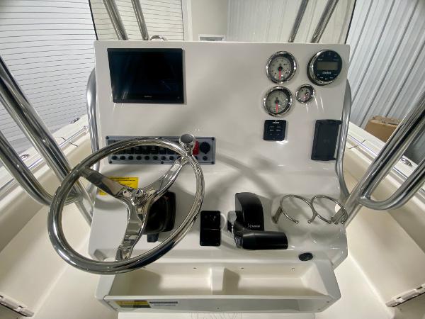 2024 Key West 219 FS boat dashboard with steering wheel, gauges, and controls.
