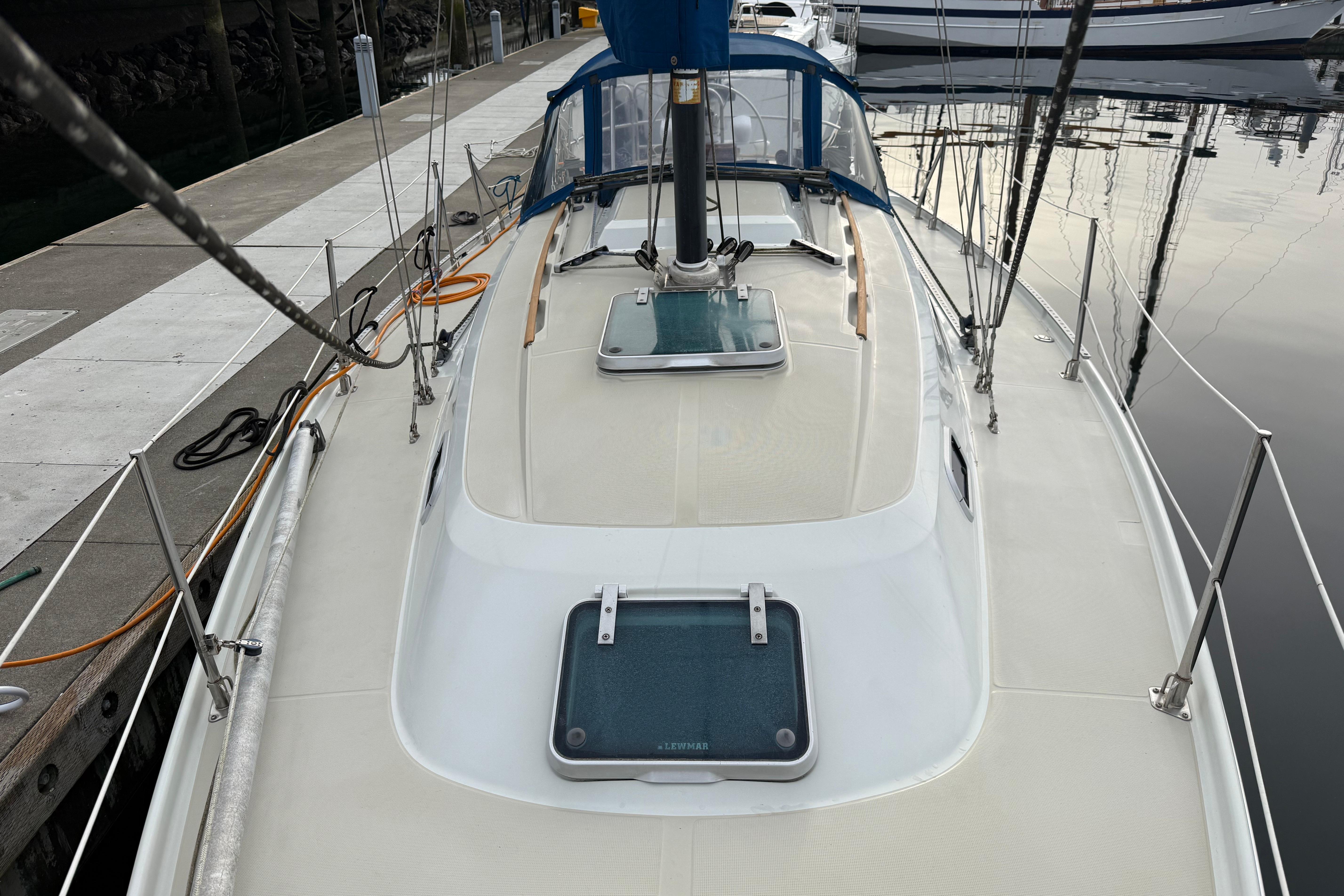 1988 Ericson 32-200 sailboat docked, showcasing deck and hatch details.