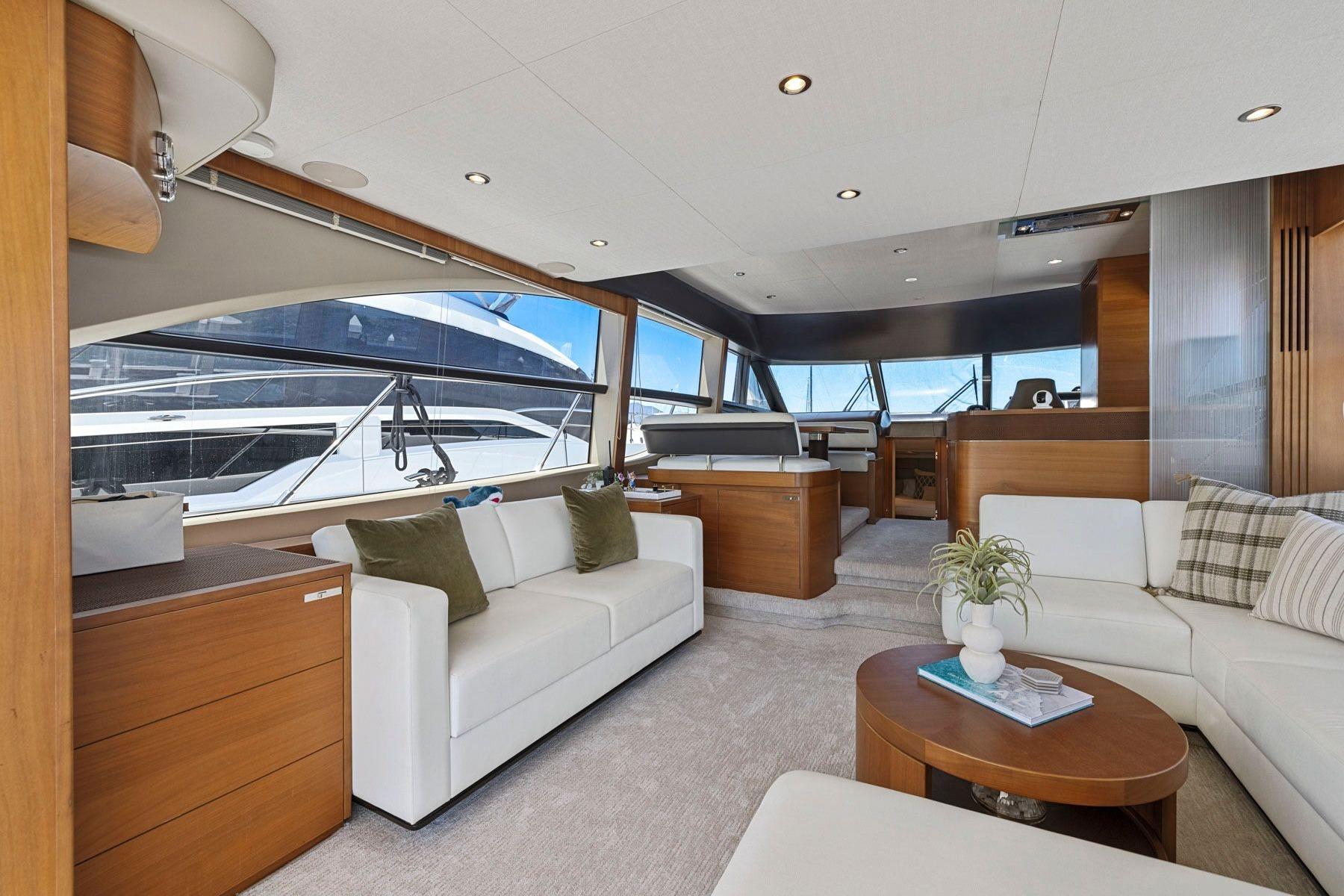 Luxurious interior of 2015 Princess 60 Flybridge Motor Yacht with elegant seating and panoramic windows.