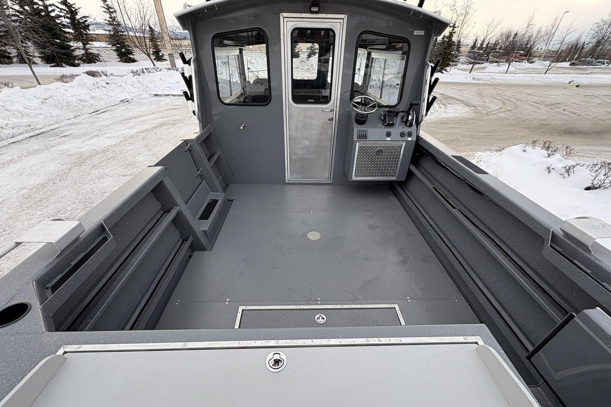 2024 Spartan 26 Maximus Pro XL boat interior with spacious deck in snowy setting.