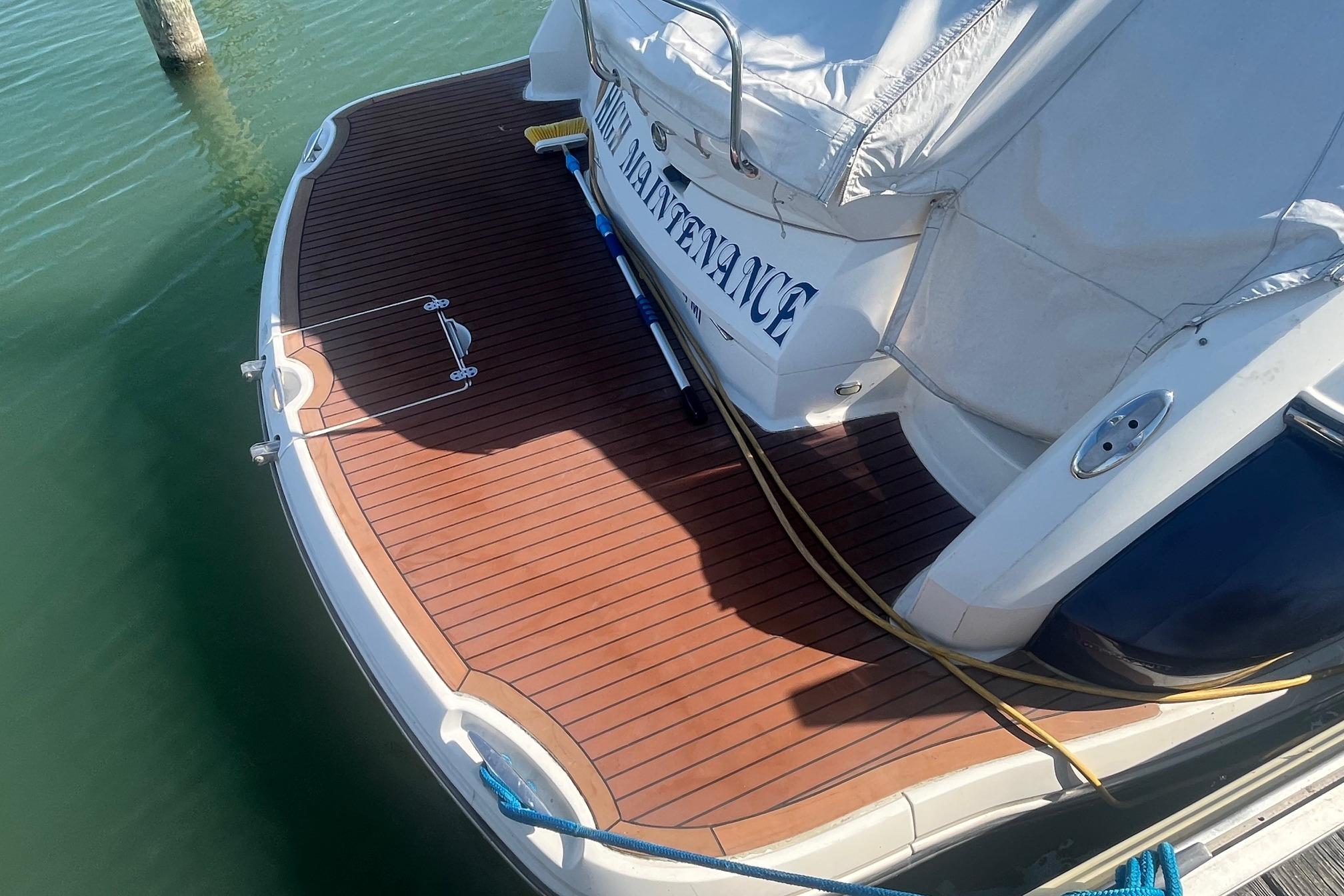 2010 Monterey 400 Sport Yacht with teak swim platform, docked in calm waters.