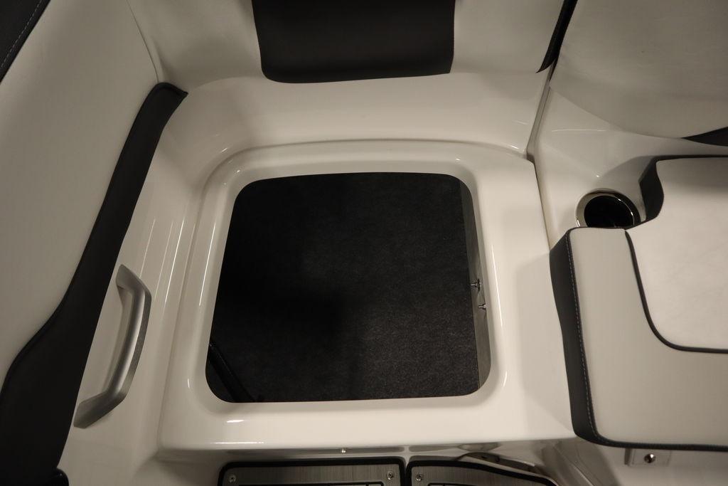 Interior view of 2026 Yamaha Boats 195S, featuring seating and storage area.