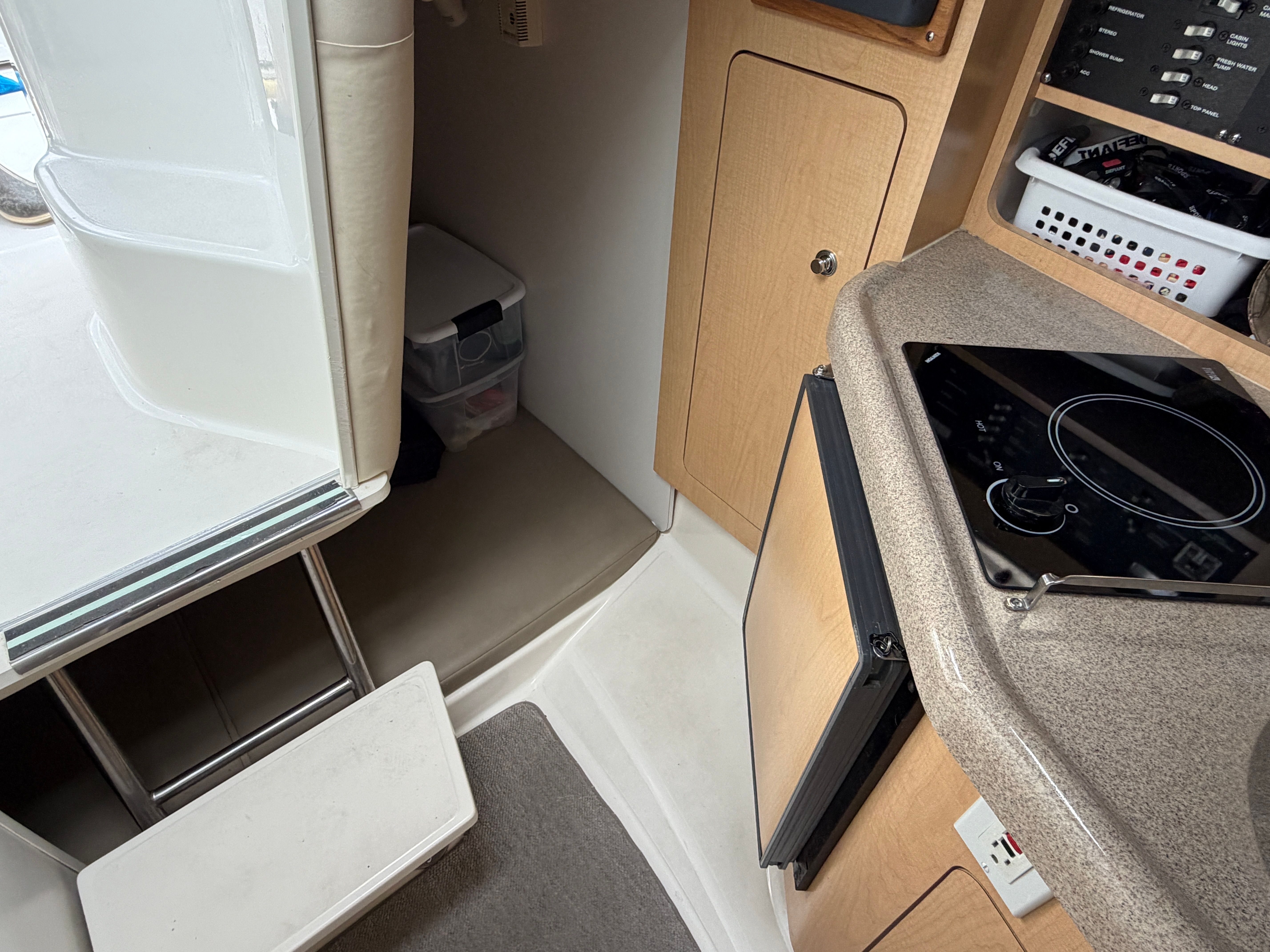 Interior of a 2001 Boston Whaler 26 Conquest with stove and refrigerator.