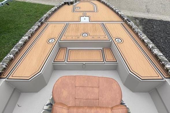 2026 Avid 21 FSX boat interior with cushioned seating and wood-patterned deck.