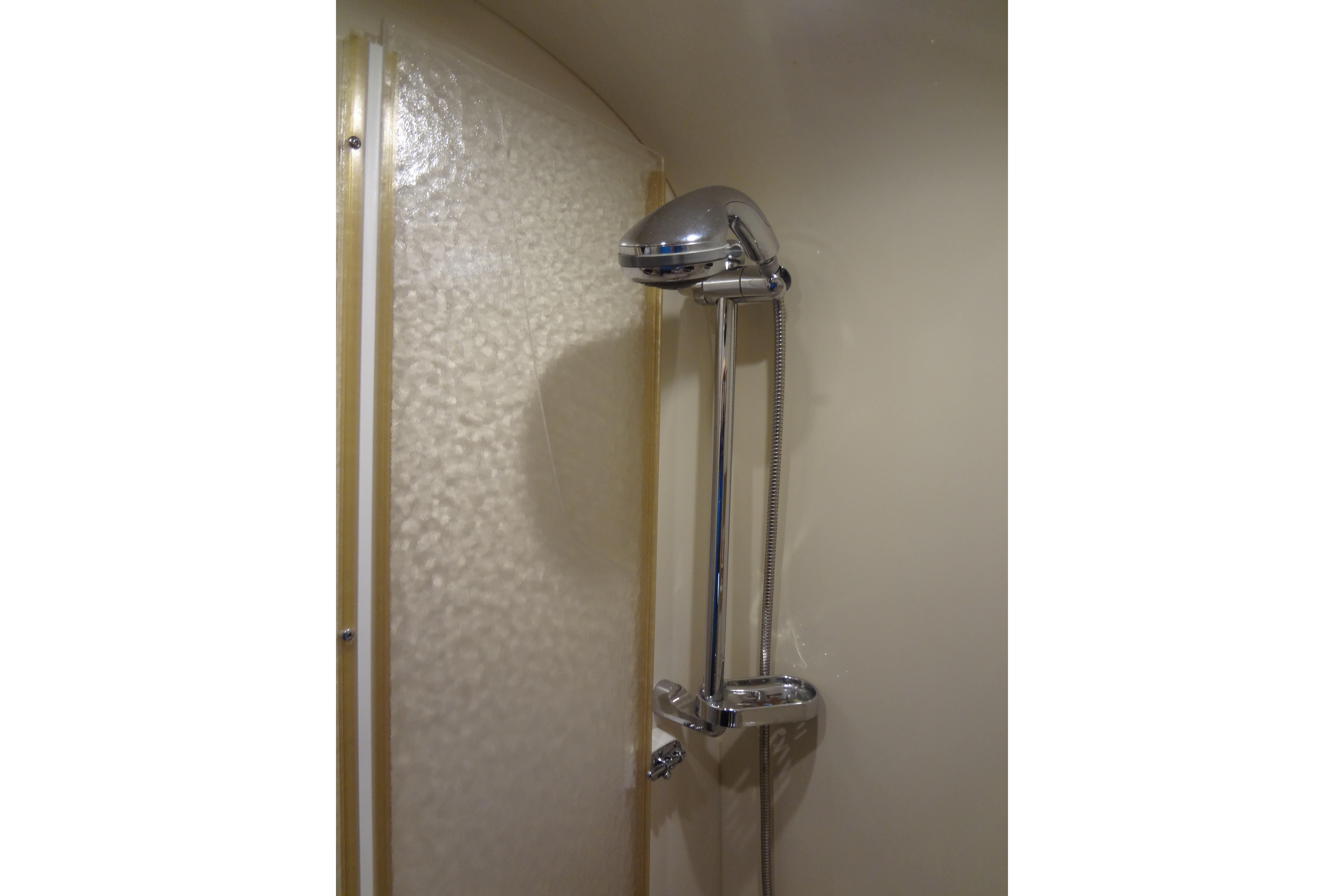Shower area in 2007 Formula 34 Performance Cruiser yacht, featuring chrome fixtures.