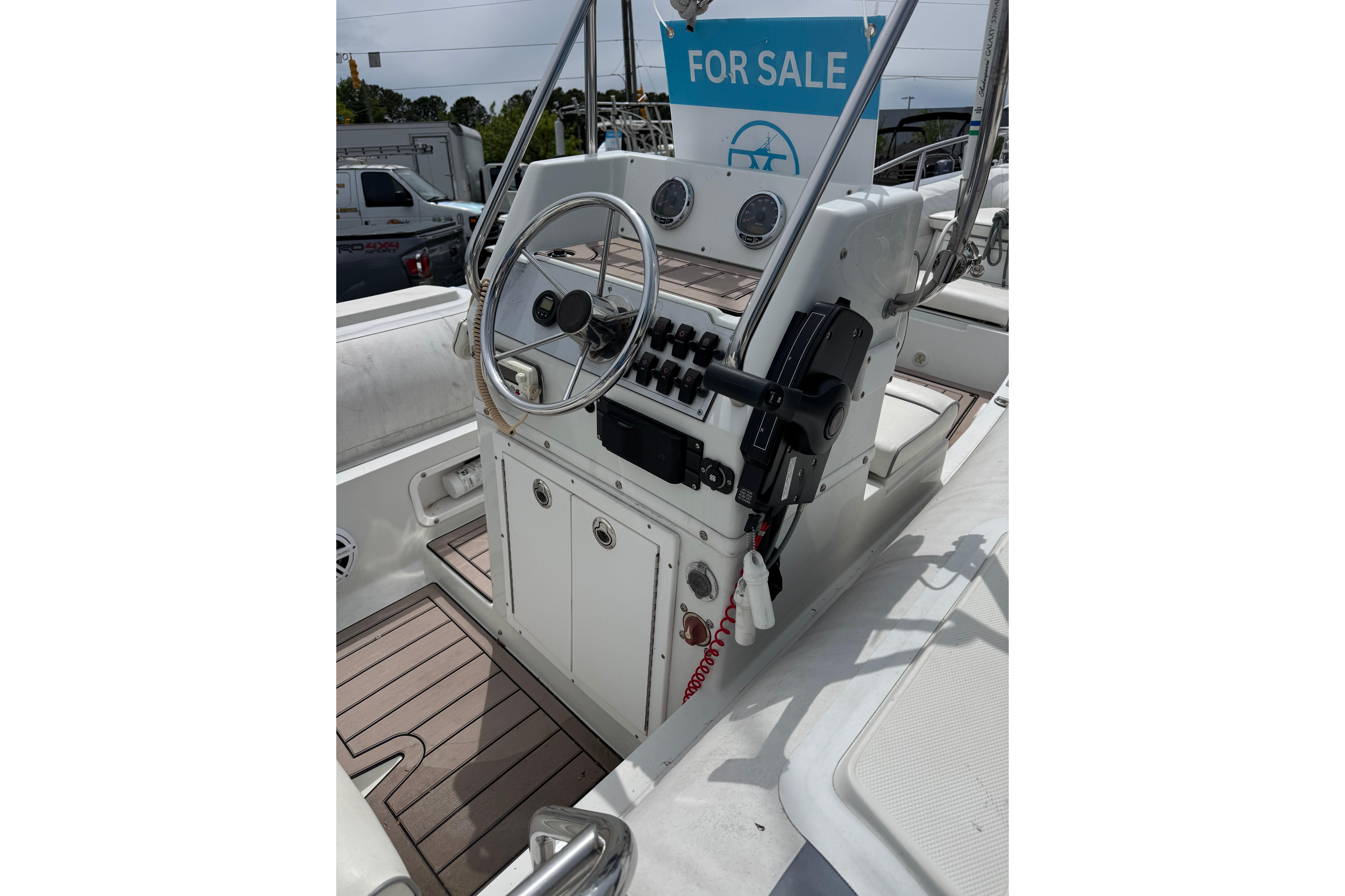 2002 Novurania 17 boat for sale, featuring a sleek control panel and steering wheel.