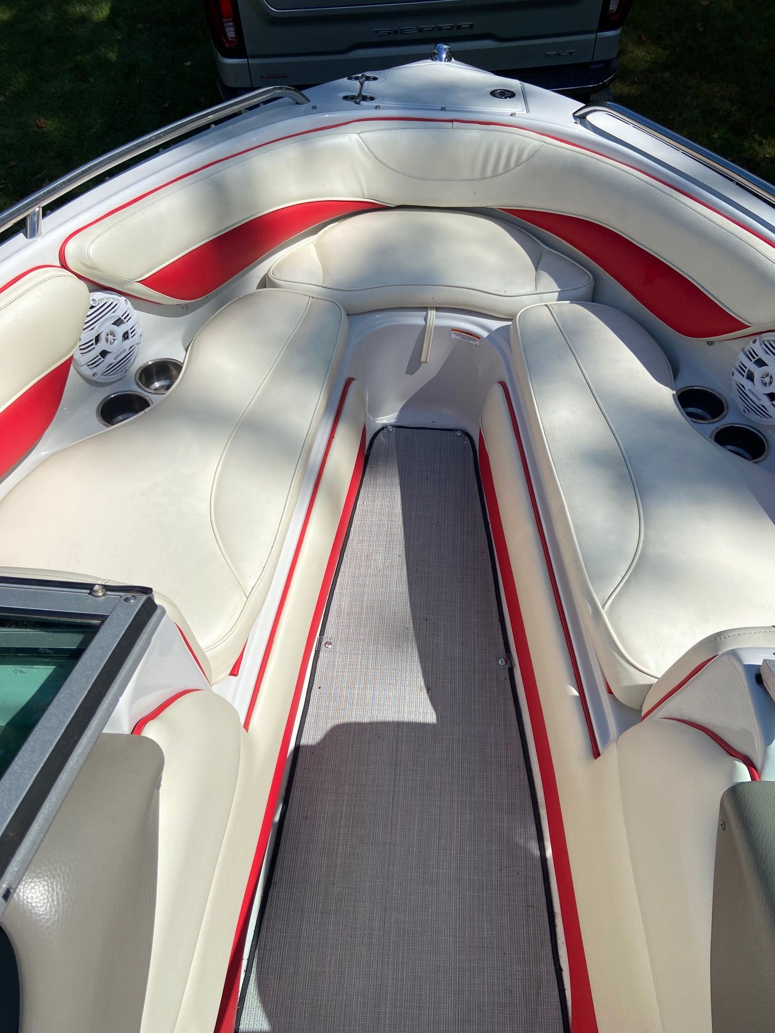 The image shows the interior of a 2011 Crownline 21 SS boat with white and red seating.