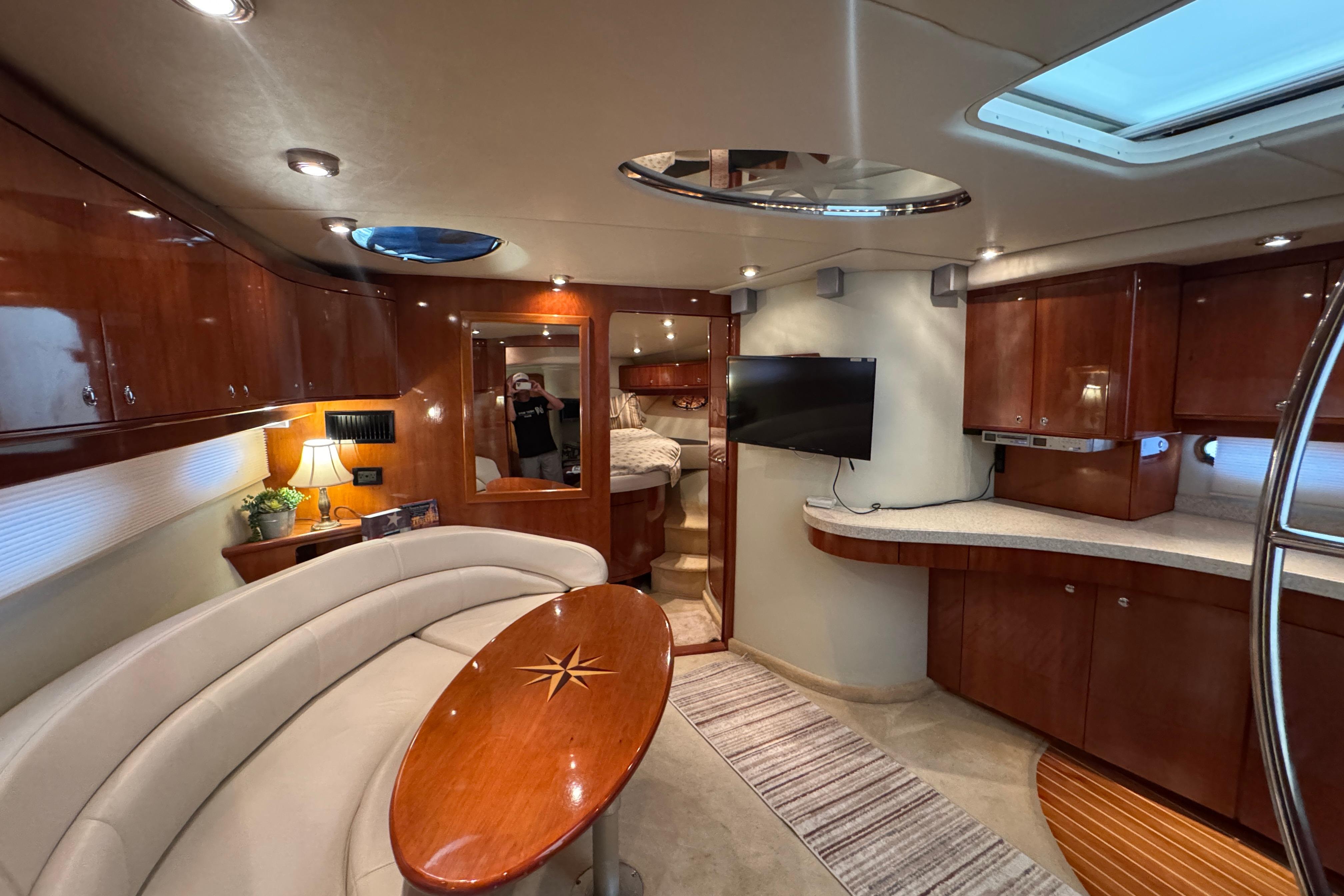 Luxurious interior of 2005 Regal Commodore 4260 yacht with elegant wood finishes and modern amenities.