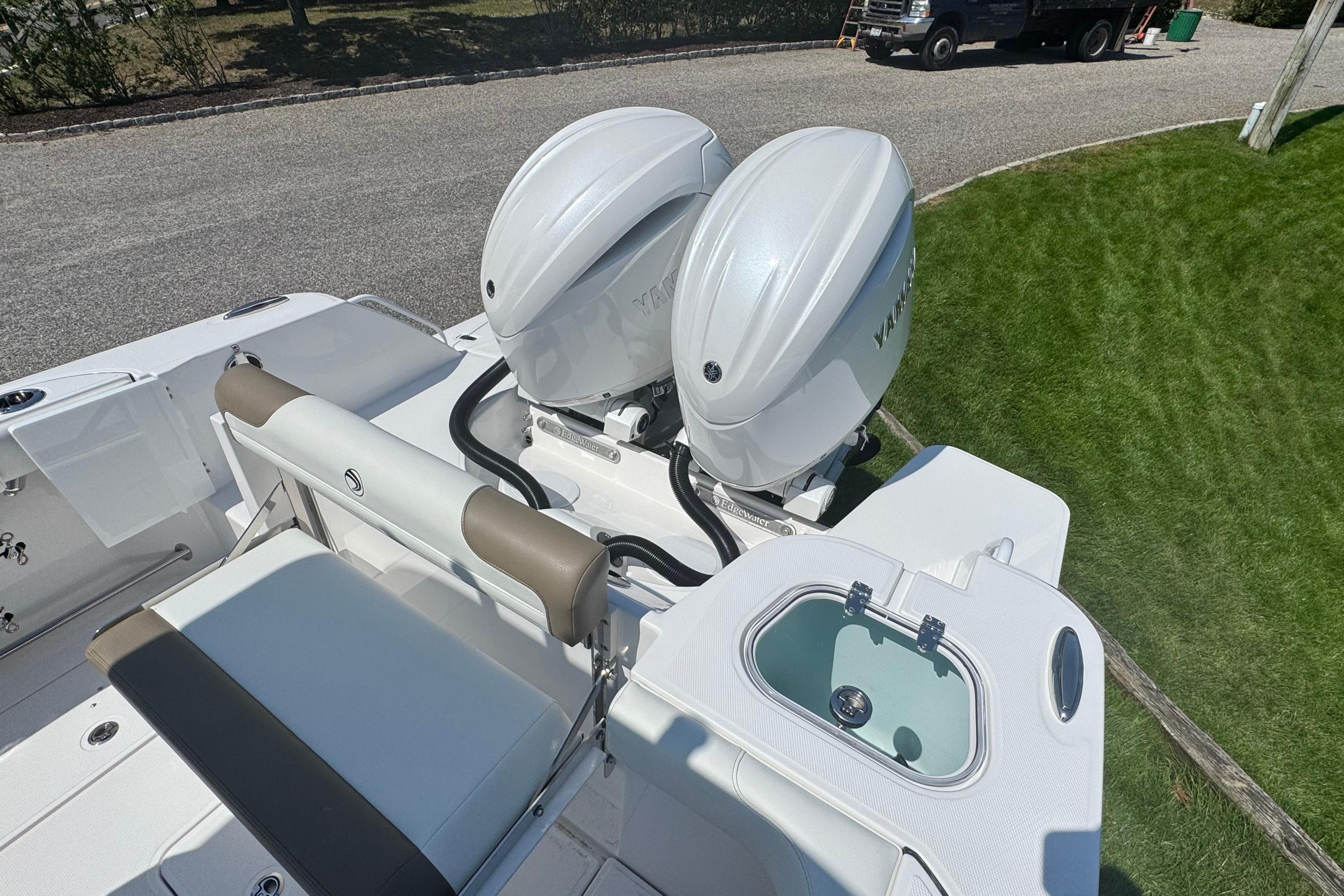 2026 Edgewater 250CC boat with dual outboard engines and seating area.