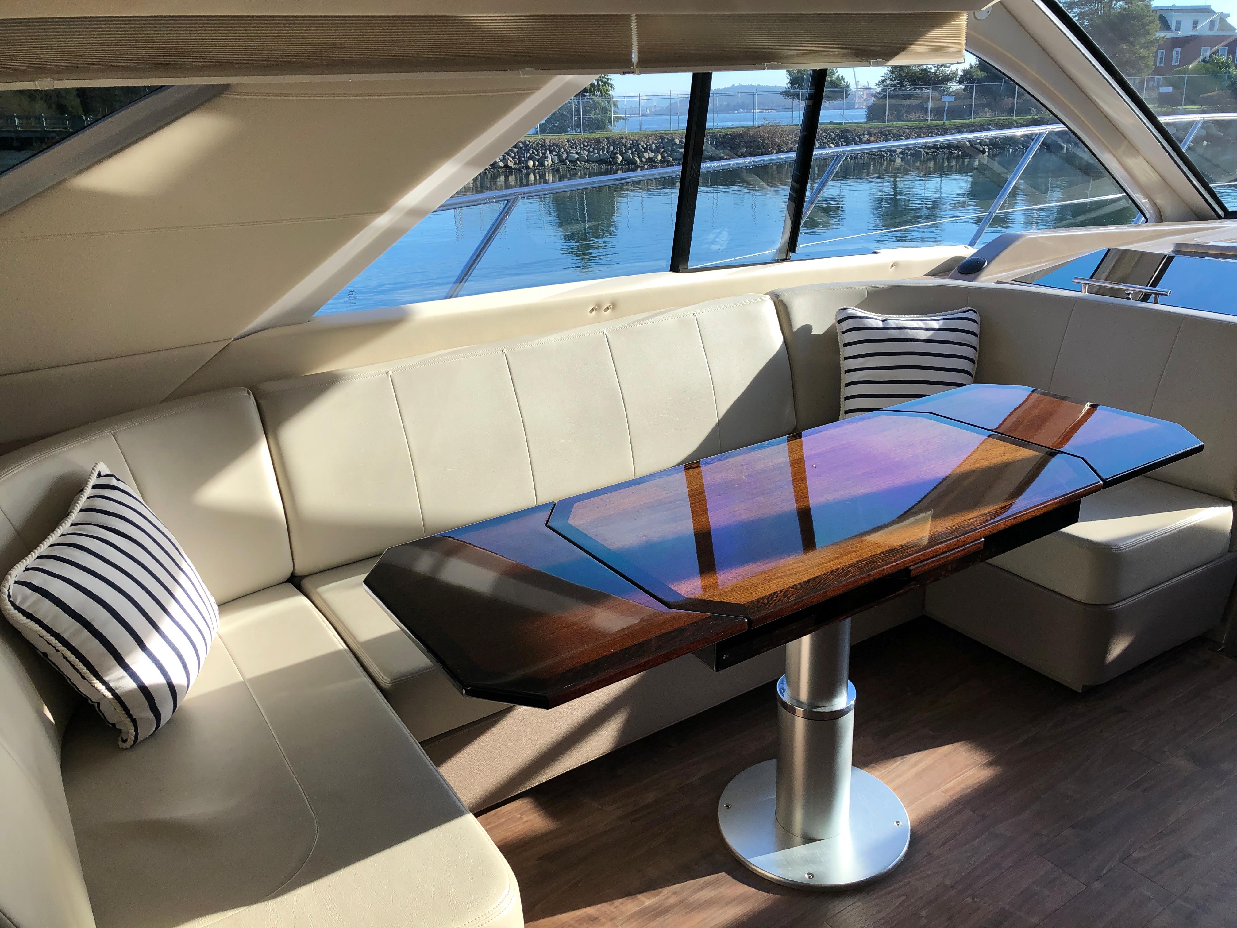 Luxurious interior of 2017 Regal 53 Sport Coupe yacht with elegant seating and table.