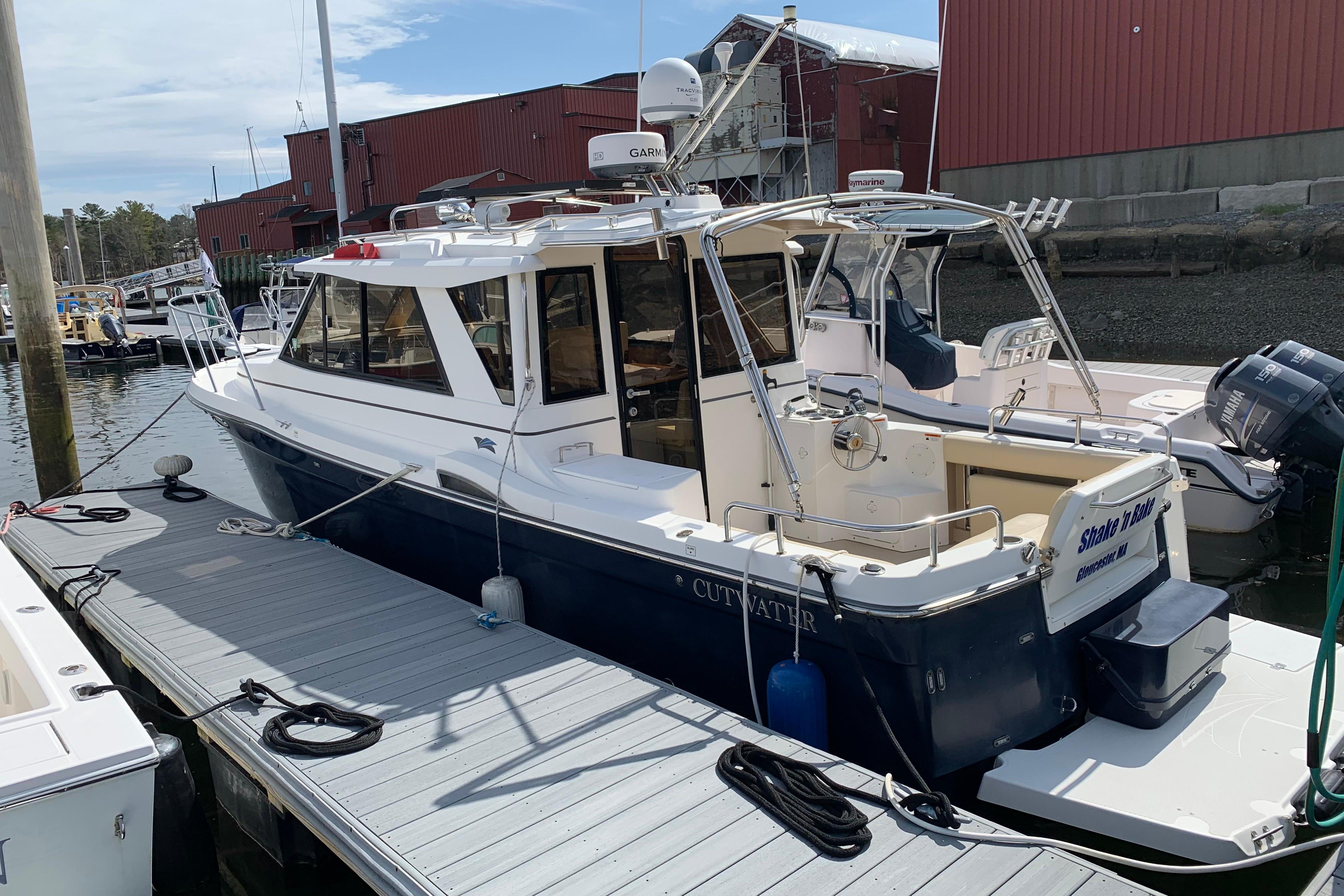 2013 Cutwater 28 LE boat docked at marina, featuring sleek design and modern equipment.