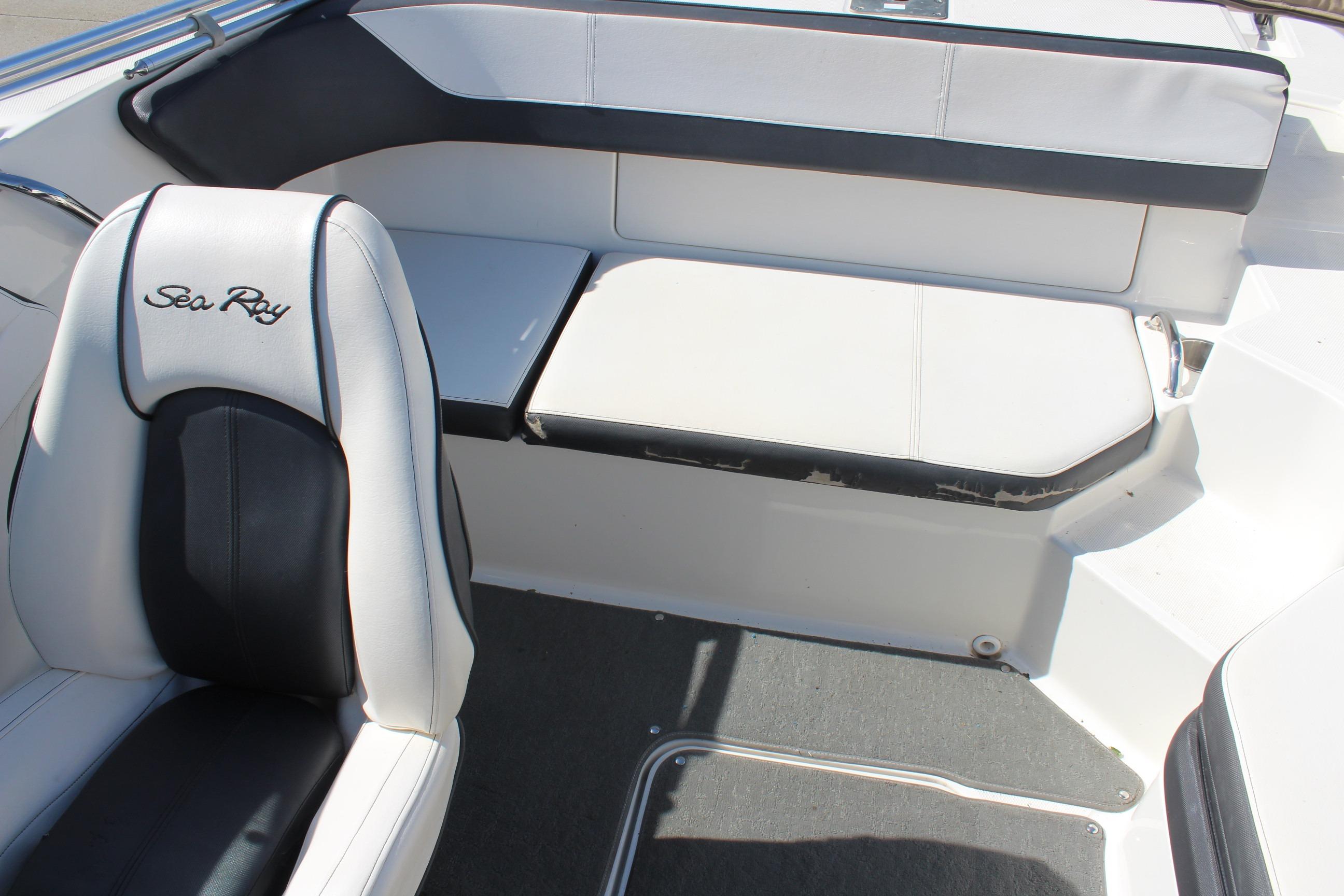 Interior seating of 2015 Sea Ray 19 SPX OB boat, featuring white and black upholstery.