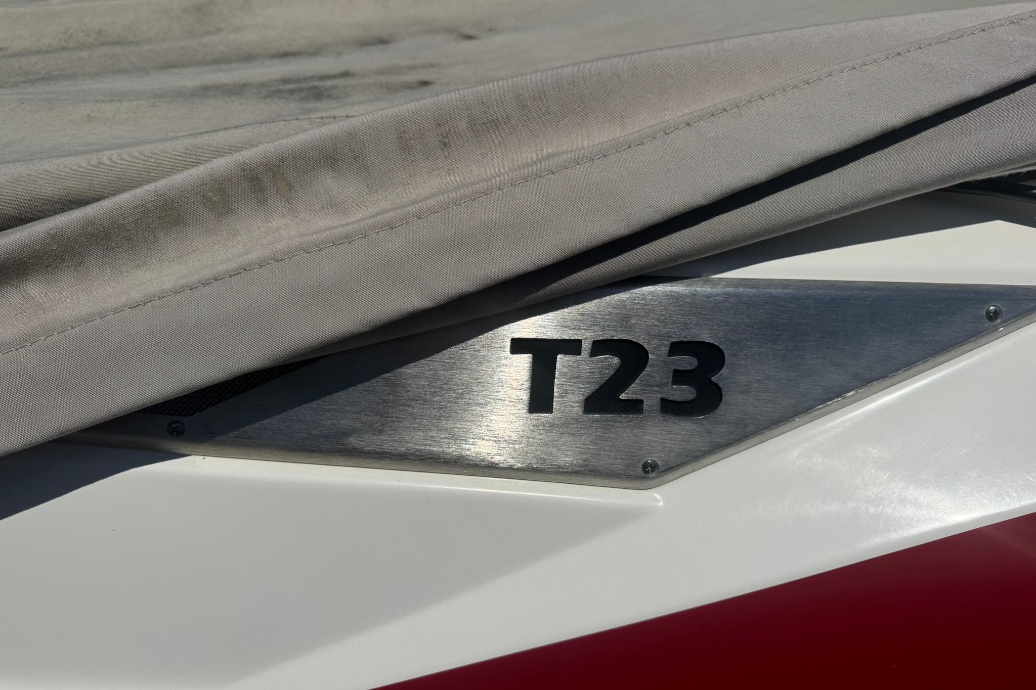 2017 Axis T23 boat partially covered, showcasing model emblem.