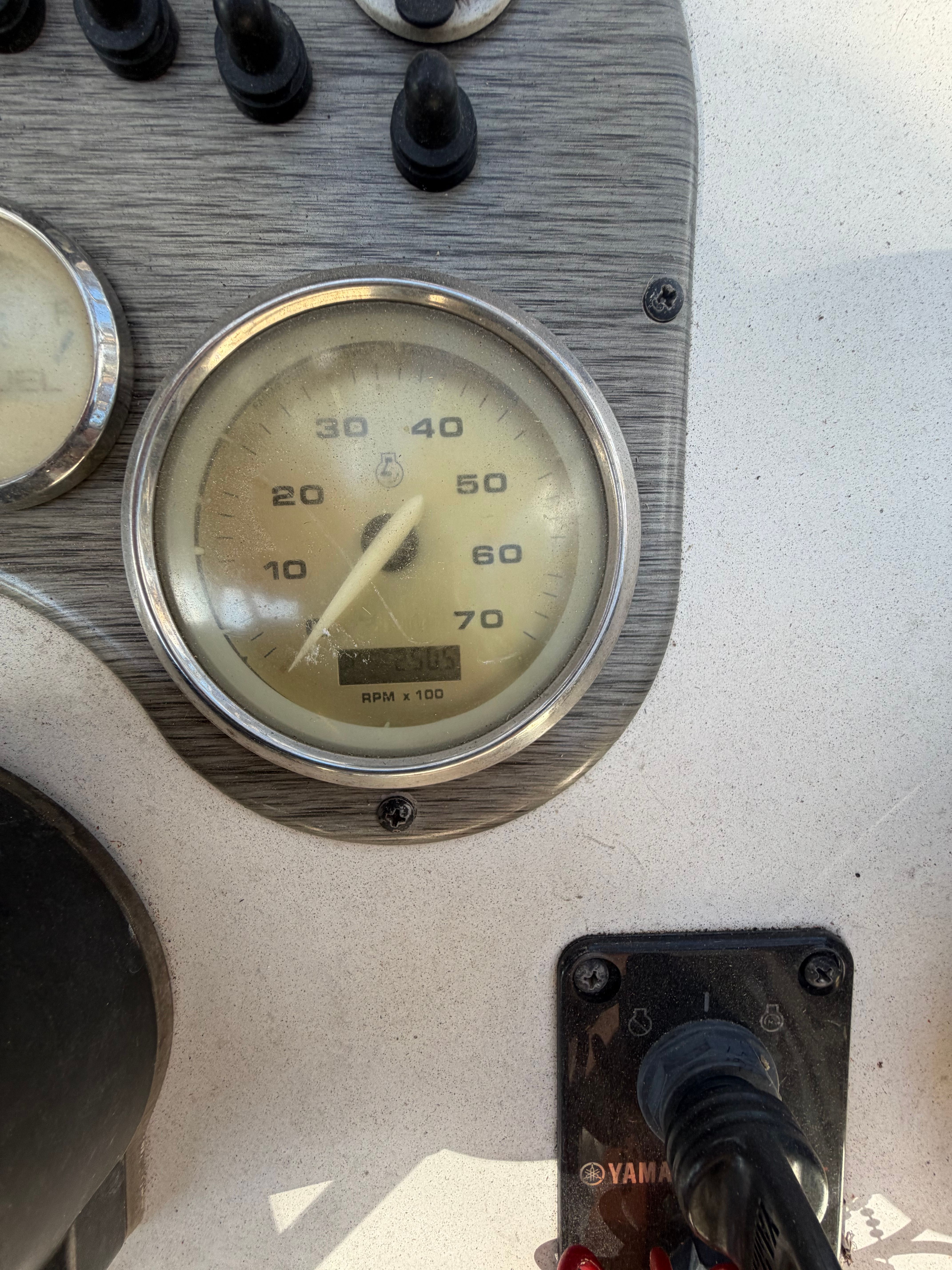 Close-up of a speedometer on a boat, displaying up to 70 MPH.