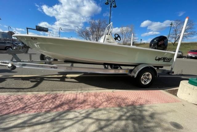 2026 Mako 18 Pro Skiff on trailer, parked outdoors under a clear blue sky.