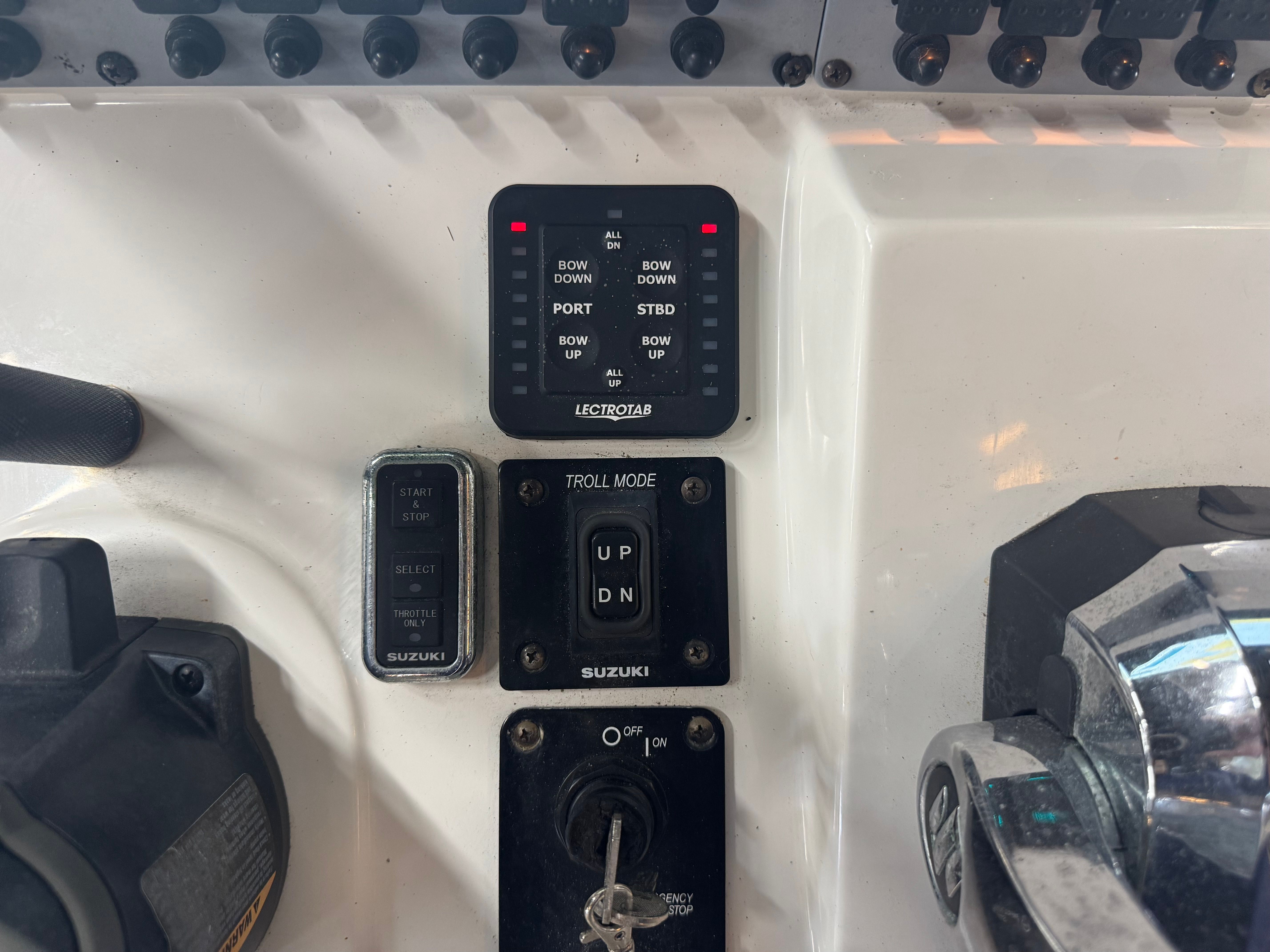 Close-up of the helm controls on a 2020 Sea Born LX24 Center Console boat.