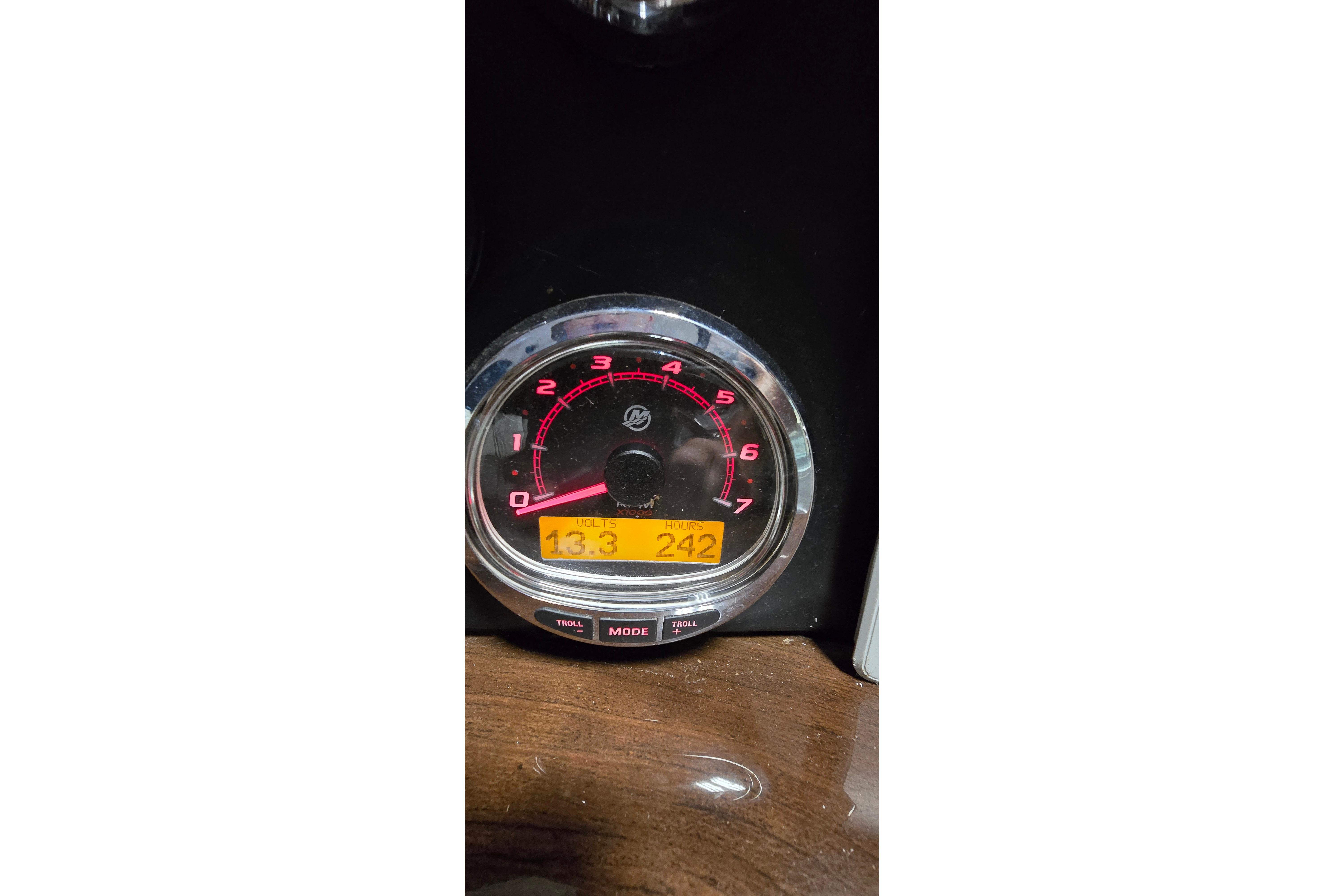 Close-up of a 2018 Four Winns V355 boat tachometer displaying 13.3 volts and 242 hours.