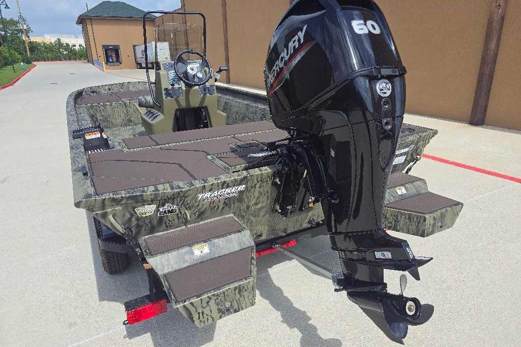 2026 Tracker Grizzly 1860 CC boat with Mercury 60 outboard motor, parked outdoors.