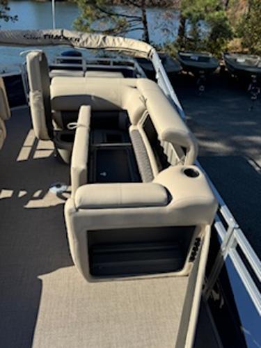 Interior of 2025 Sun Tracker Fishin' Barge 22 DLX with beige seating.
