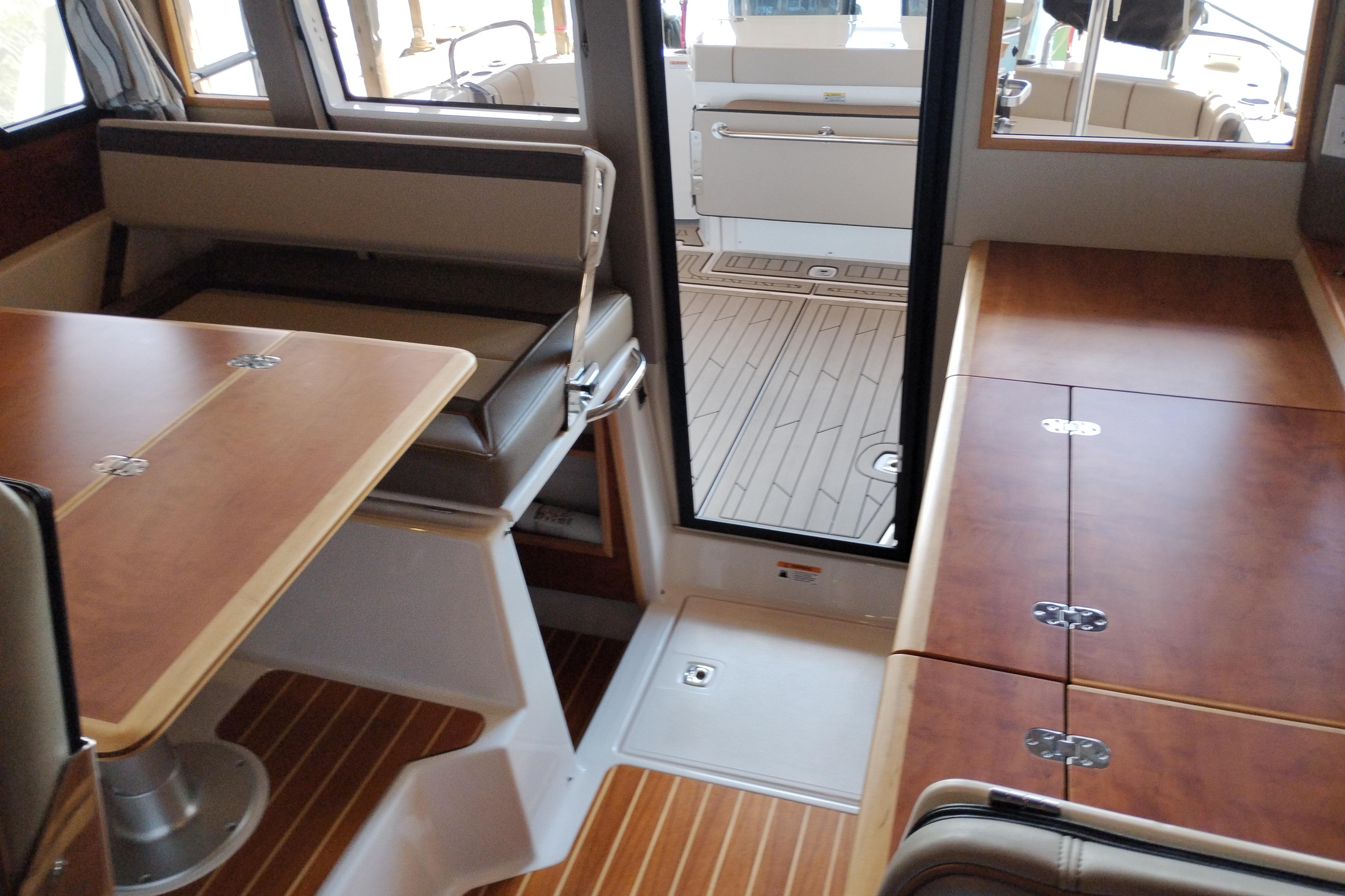 Interior of 2022 Cutwater C-32 Coupe, featuring wood finishes and seating area.